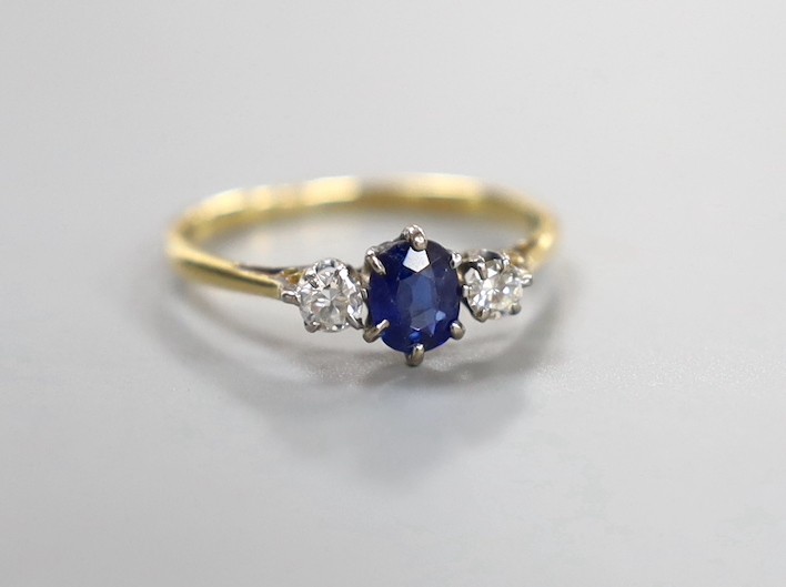 An 18ct & plat, sapphire and diamond set three stone ring, size O, gross weight 2 grams.                                                                                                                                    