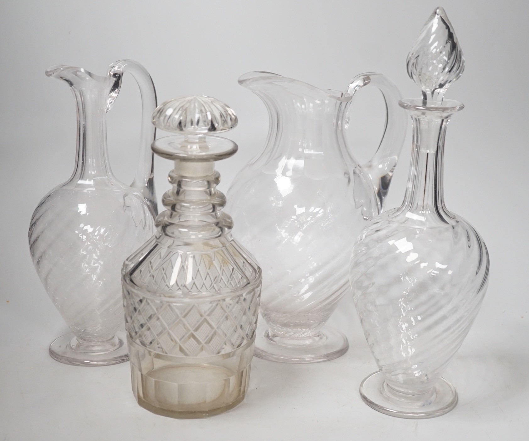 Two Victorian cut glass decanters, a ewer and a jug. Tallest 32cm                                                                                                                                                           