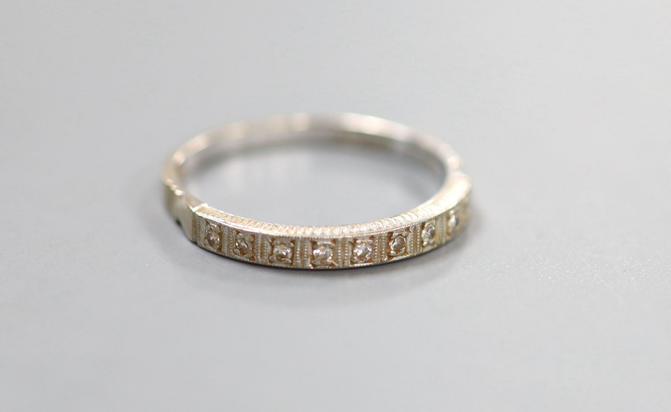 A modern 18ct white gold and diamond chip set half eternity ring. size Q, gross weight 2.5 grams.                                                                                                                           