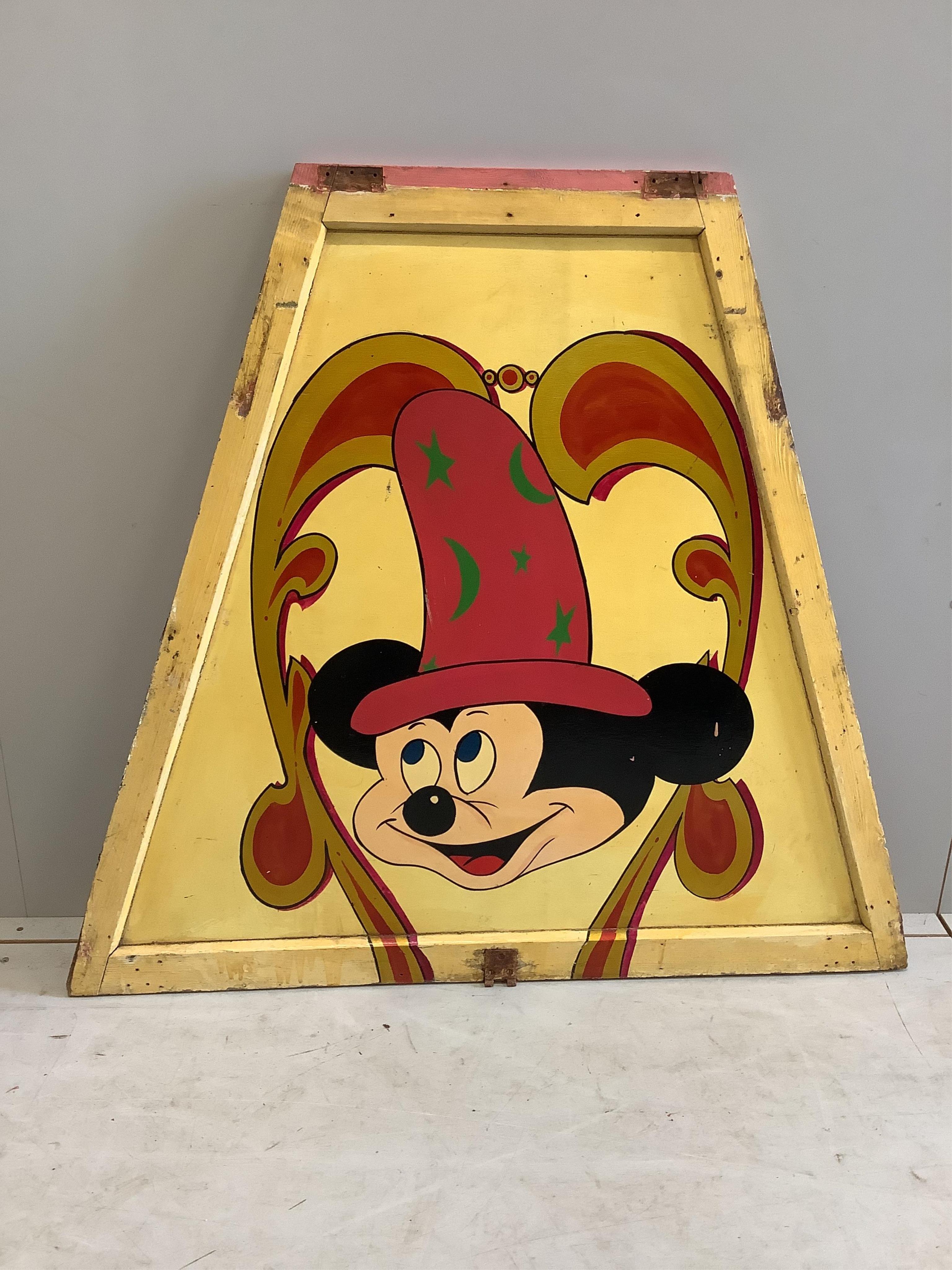 A mid century “Mickey Mouse” painted wood fairground carousel panel of tapered rectangular form, width 104cm, height 94cm. Condition - fair                                                                                 