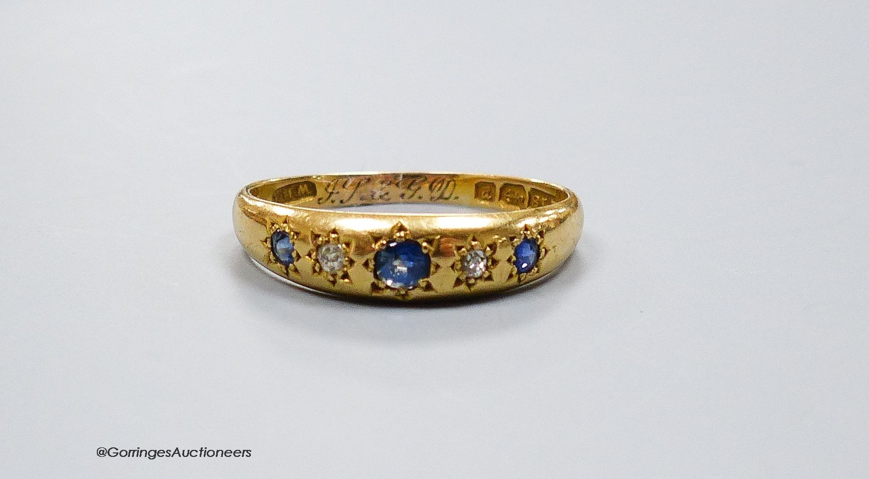 An 18ct gold sapphire and diamond 5-stone ring, size R, gross 2g.                                                                                                                                                           