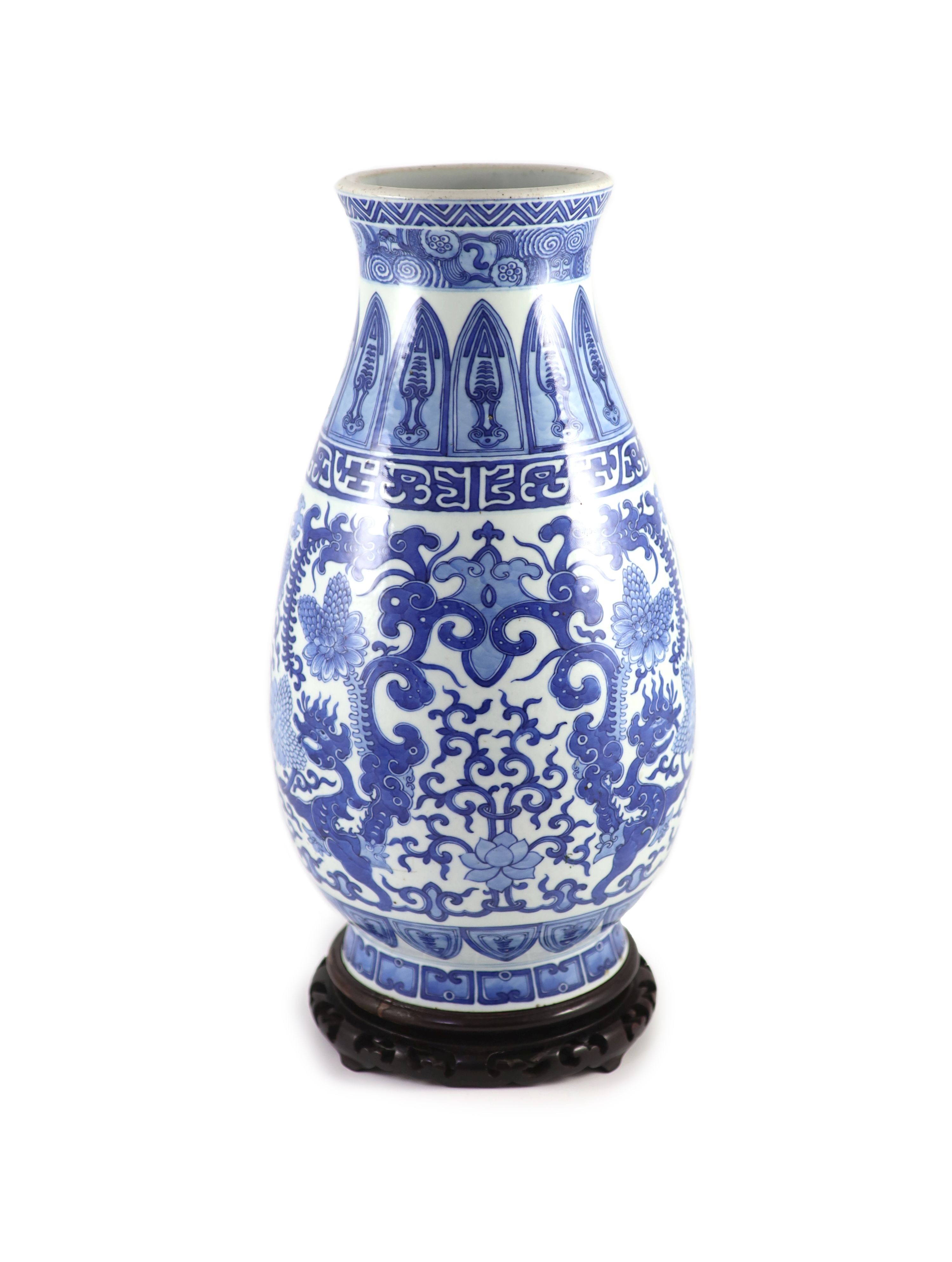 A Chinese archaistic blue and white pear-shaped vase, Qianlong mark but 19th century, 44.5 cm high, wood stand                                                                                                              