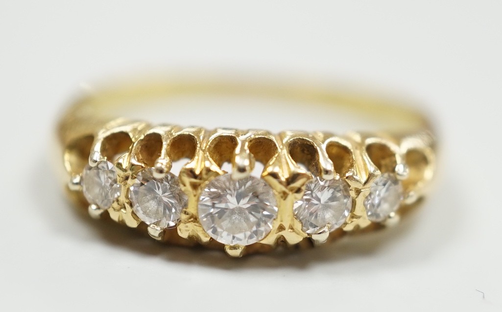 An early 20th century gold and graduated five stone diamond set half hoop ring, size O/P, gross weight 4.3 grams.                                                                                                           