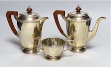 A George VI panelled silver coffee pot, hot water pot and sugar bowl by Mappin & Webb, Sheffield, 1947, gross weight 30.9oz.                                                                                                