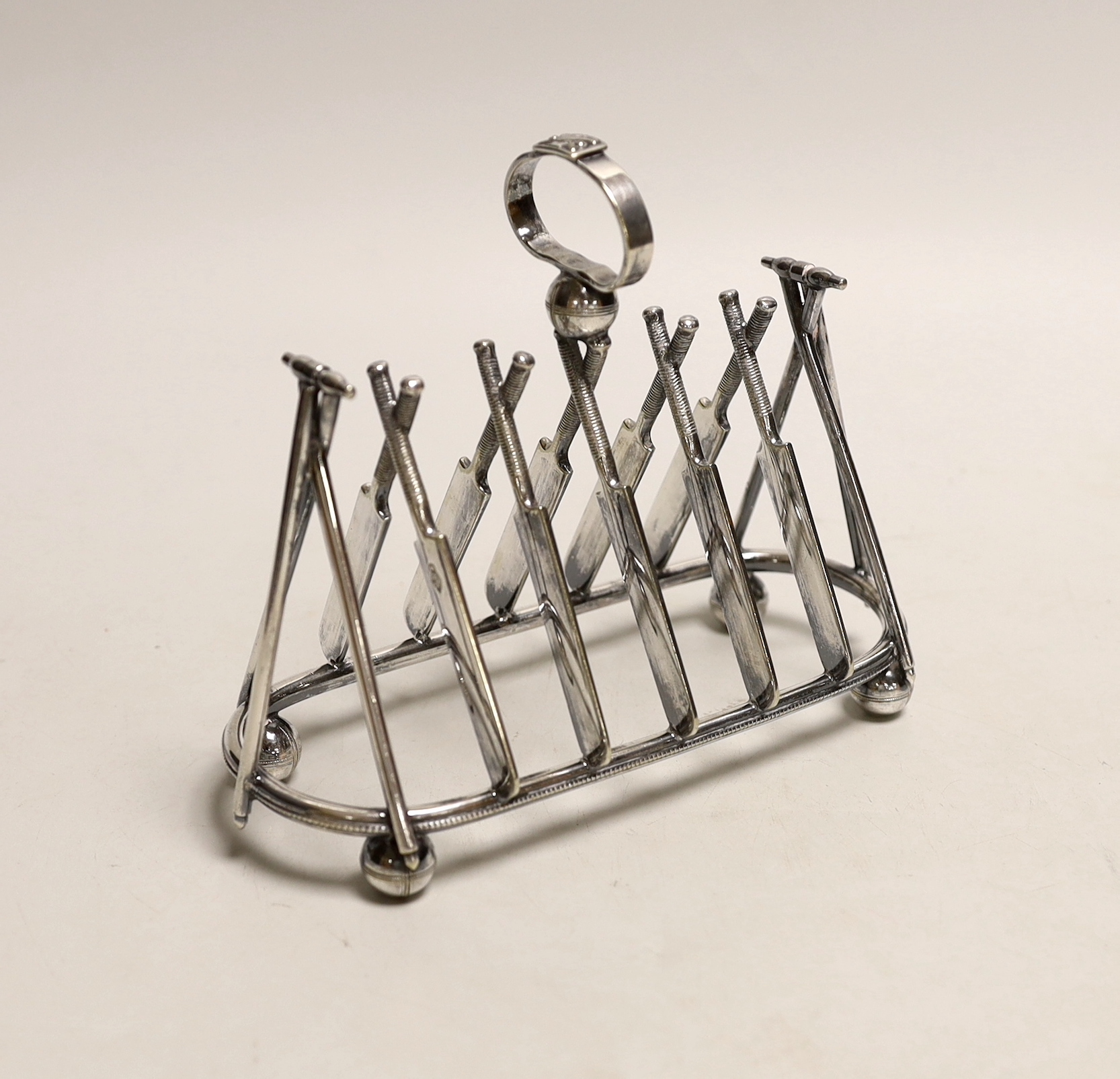 A Victorian EPNS novelty ‘cricket’ toast rack, 18cm wide, 15cm high                                                                                                                                                         