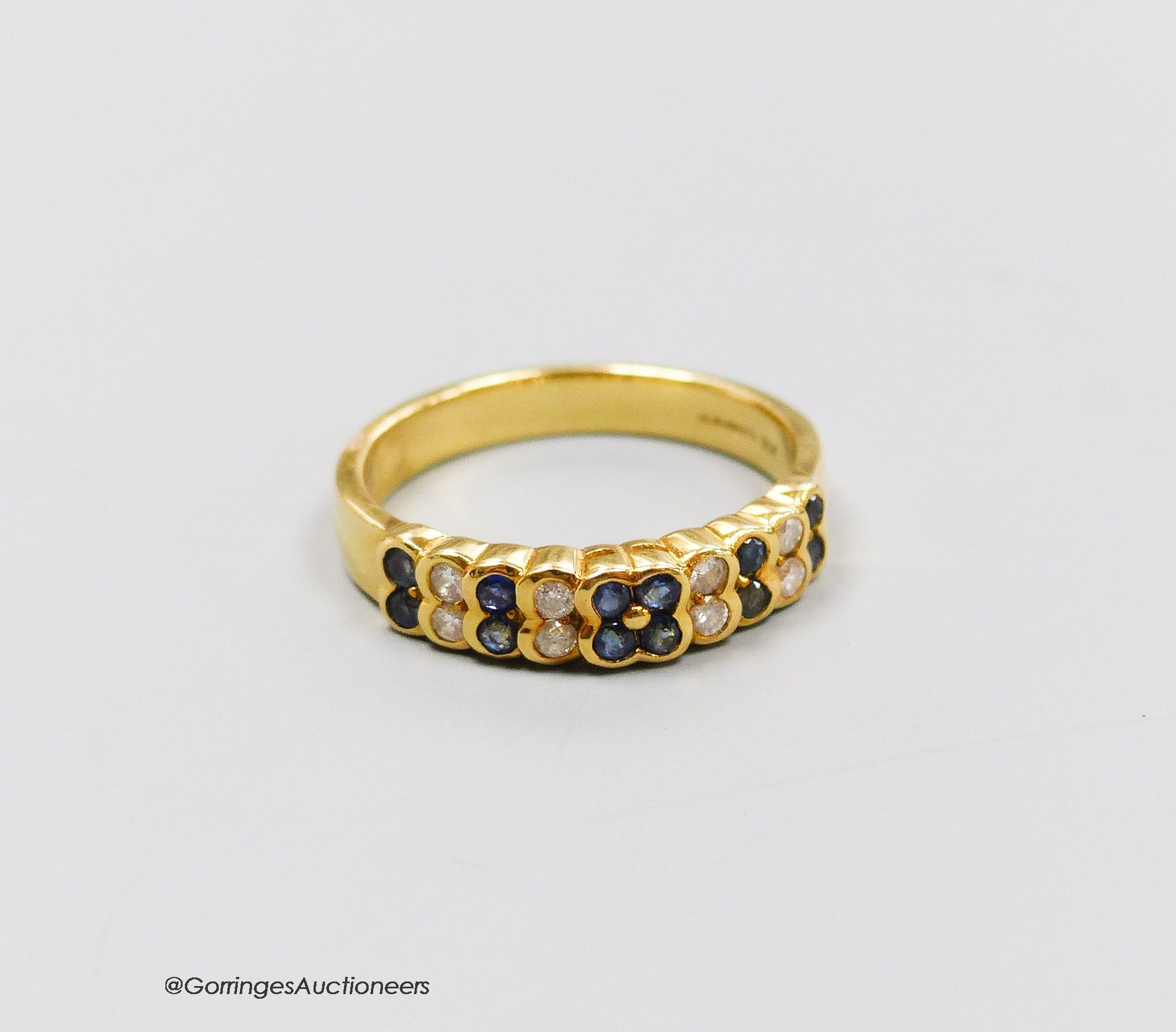 An 18ct gold sapphire and diamond half hoop ring, size R, gross 4g.                                                                                                                                                         