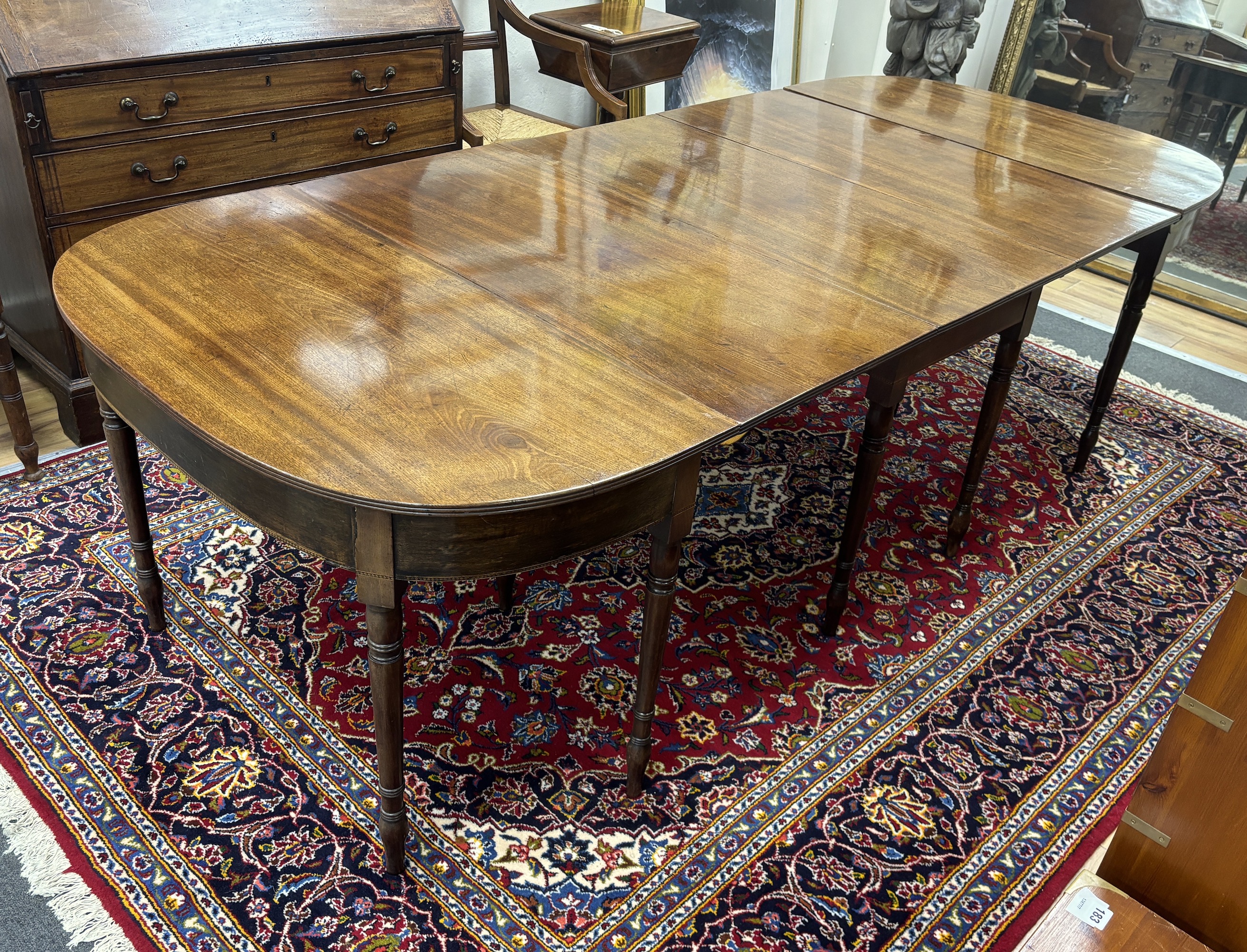 A Regency mahogany D end extending dining table, 257cm extended, width 109cm, height 70cm                                                                                                                                   