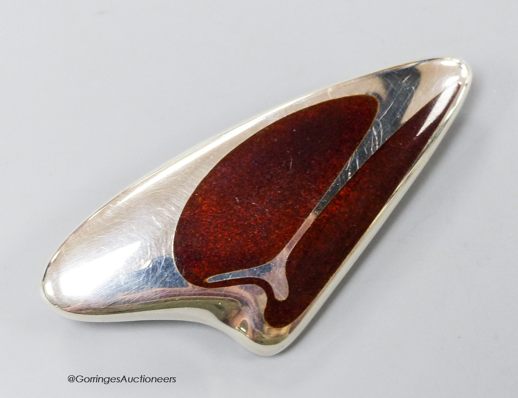 A Georg Jensen sterling and brown enamelled amorphic brooch, designed by Henning Koppel, no.314, 68mm.                                                                                                                      