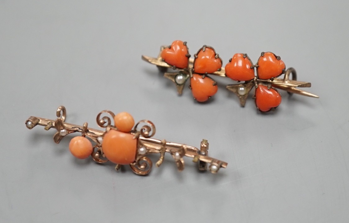 Two early 20th century yellow metal seed pearl and coral set brooches, one stamped 333 (8ct), largest 38mm, gross weight 3.8 grams.                                                                                         