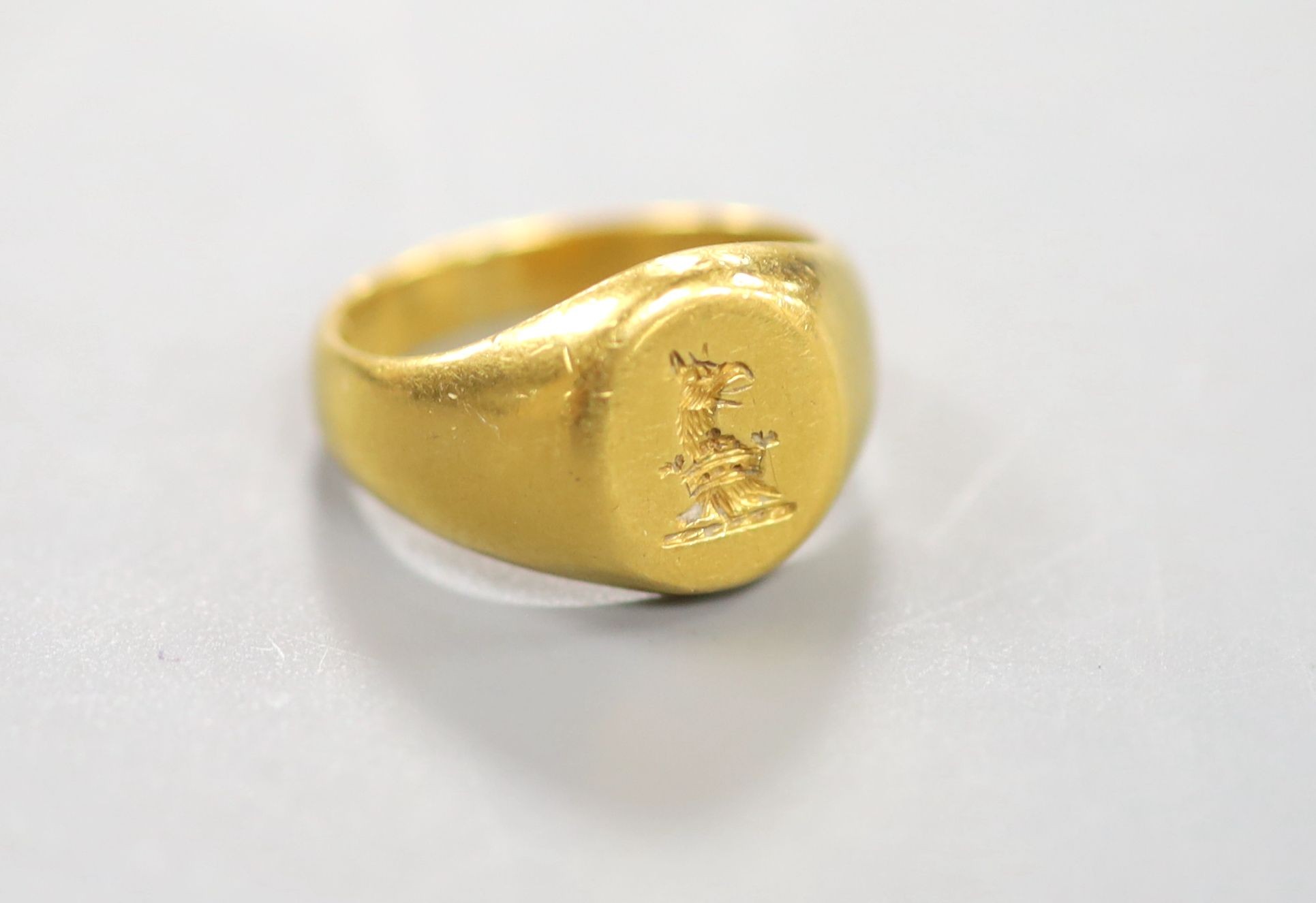 An early 20th century yellow metal(stamped 22) intaglio crested signet ring, size J, 8.6 grams.                                                                                                                             