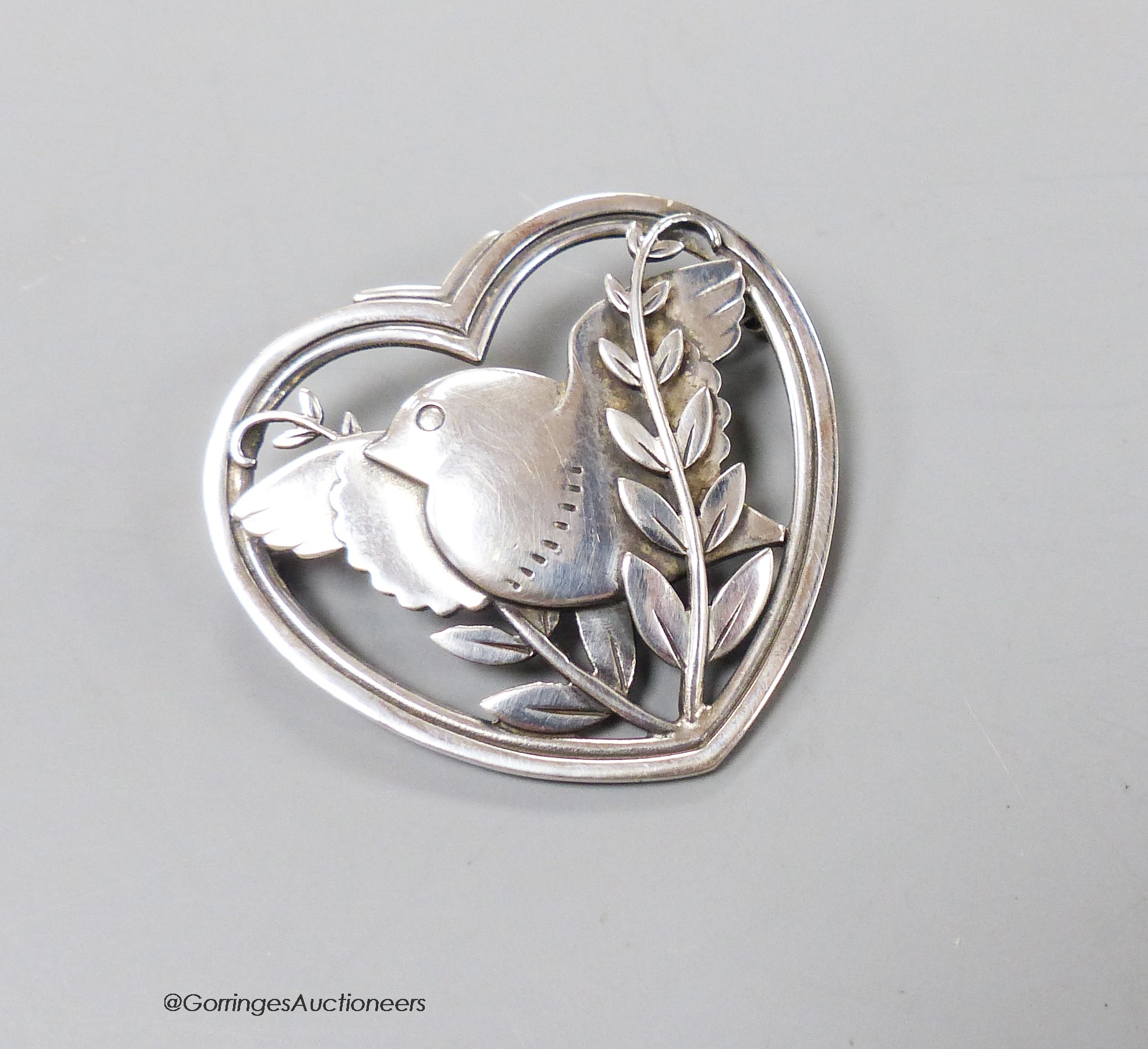 A Georg Jensen sterling heart shaped, 'bird amid foliage' brooch, design no. 239, 37mm.                                                                                                                                     