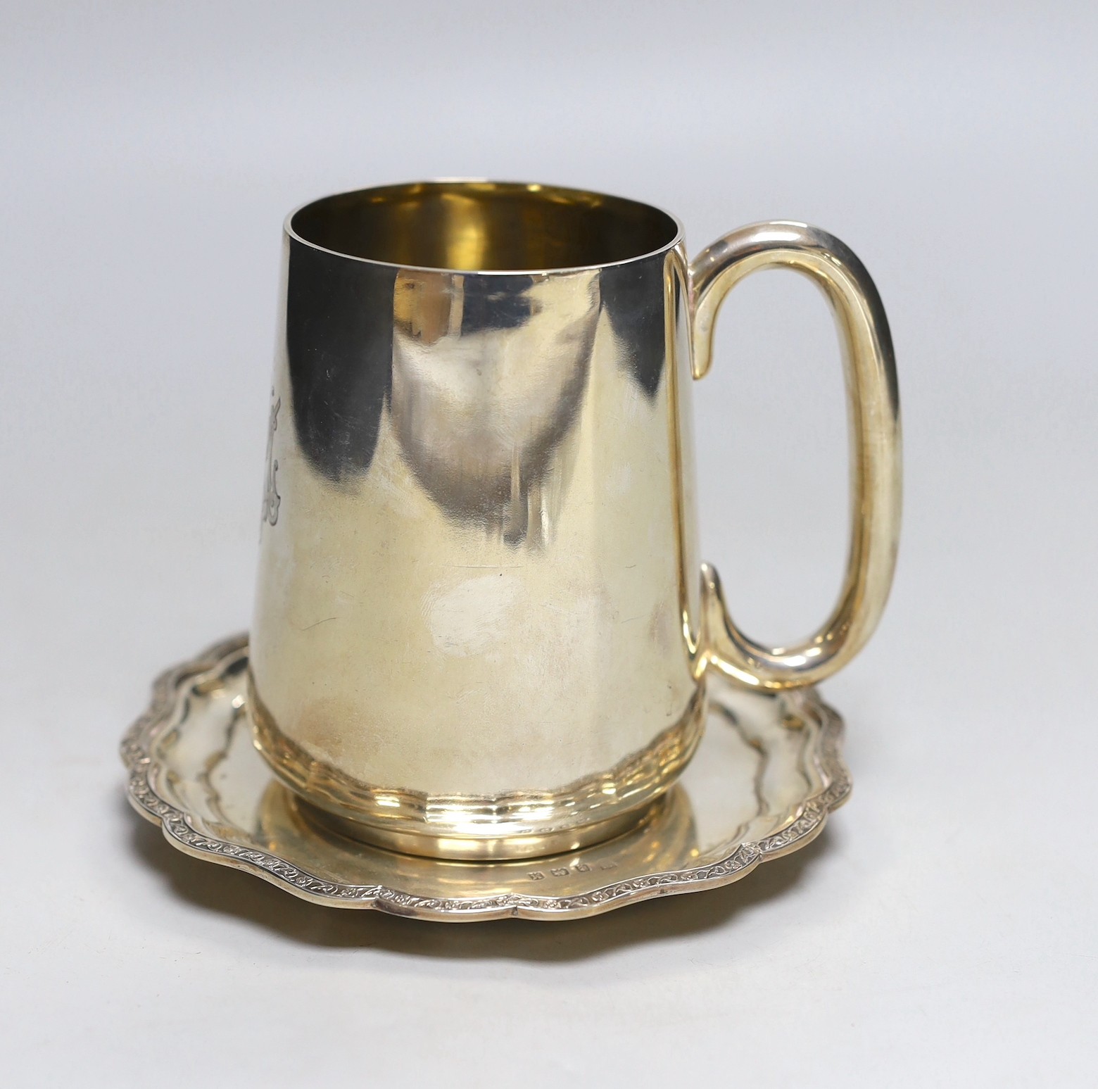 A Victorian silver mug, John Newton Mappin, Sheffield, 1877, height 11.2cm and a later silver waiter, with engraved inscription, 13.8oz.                                                                                    