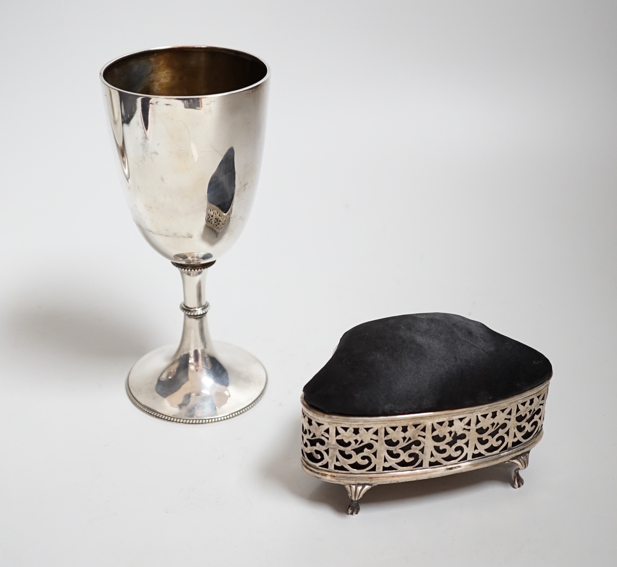 A Victorian silver goblet, Mappin & Webb, London, 1876, 17cm, a George V pierced silver mounted pin cushion/trinket box and a lady's rolled gold wrist watch.                                                               