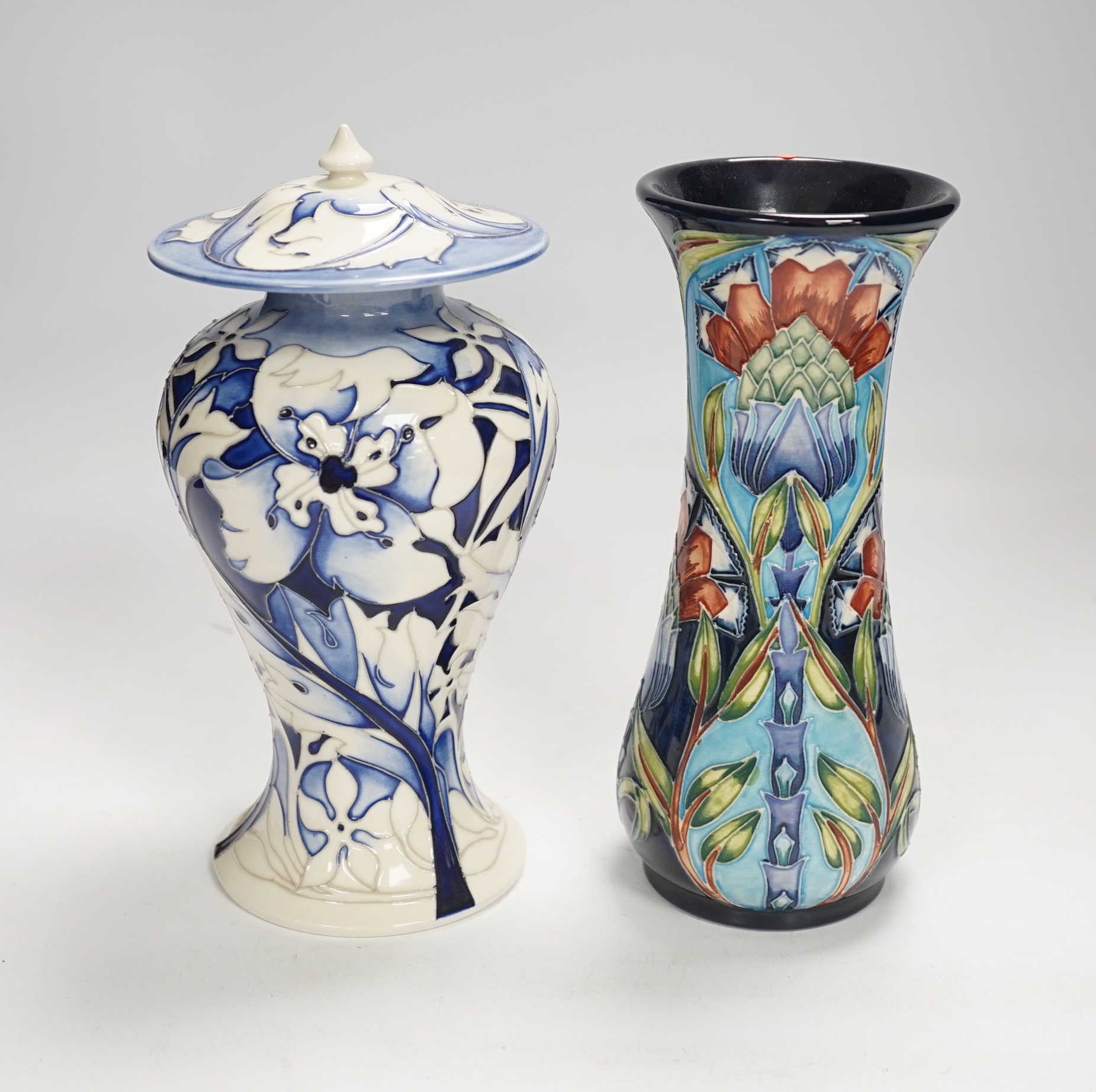 A Moorcroft floral vase designed by Shirley Hayes, limited edition 27/30 and a Moorcroft blue and white jar and cover by Emma Bossons, limited edition 2/3, largest 23cm high                                               