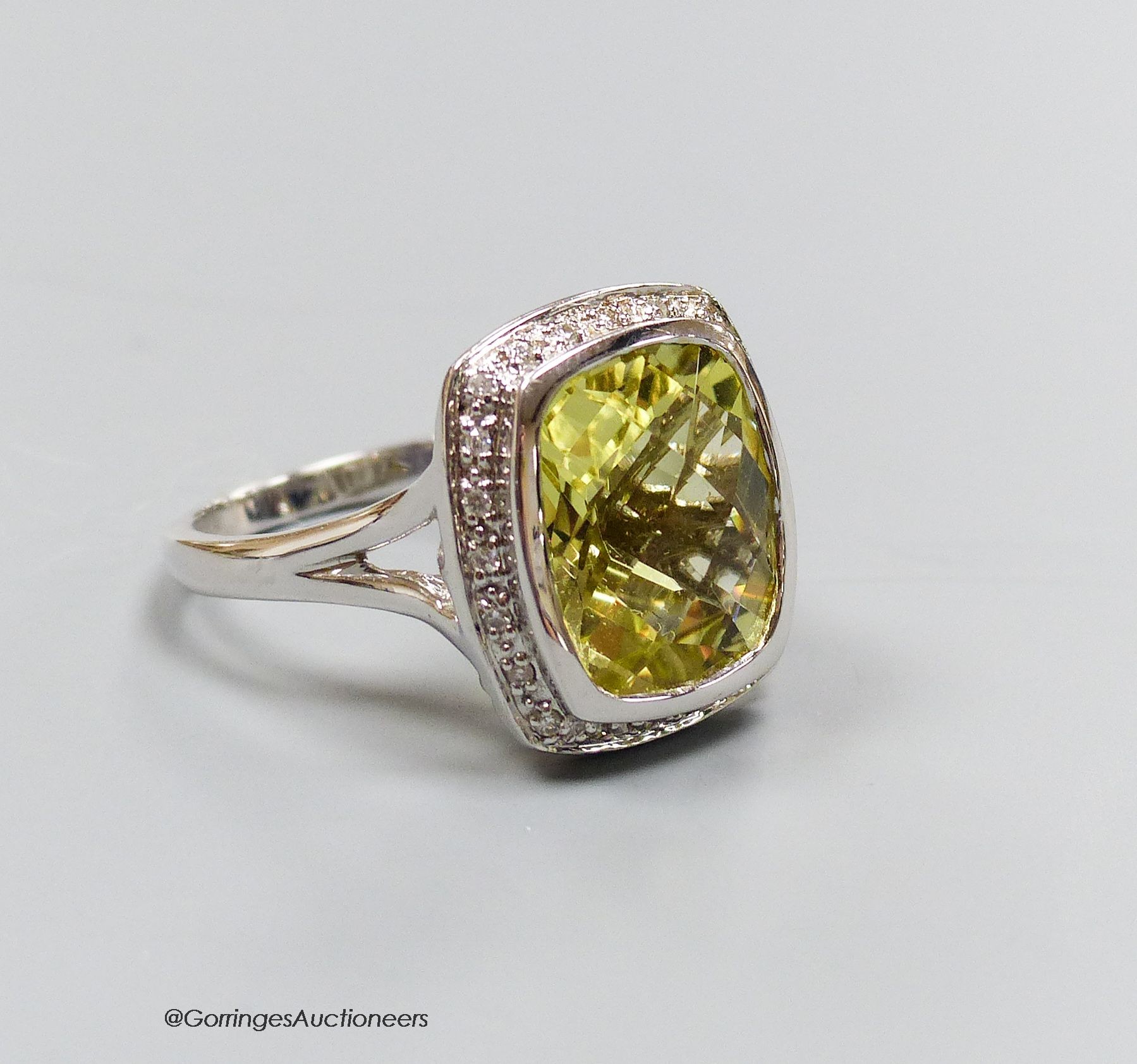 An 18ct white gold, diamond and lemon quartz cluster ring, size N, gross 7.3g.                                                                                                                                              