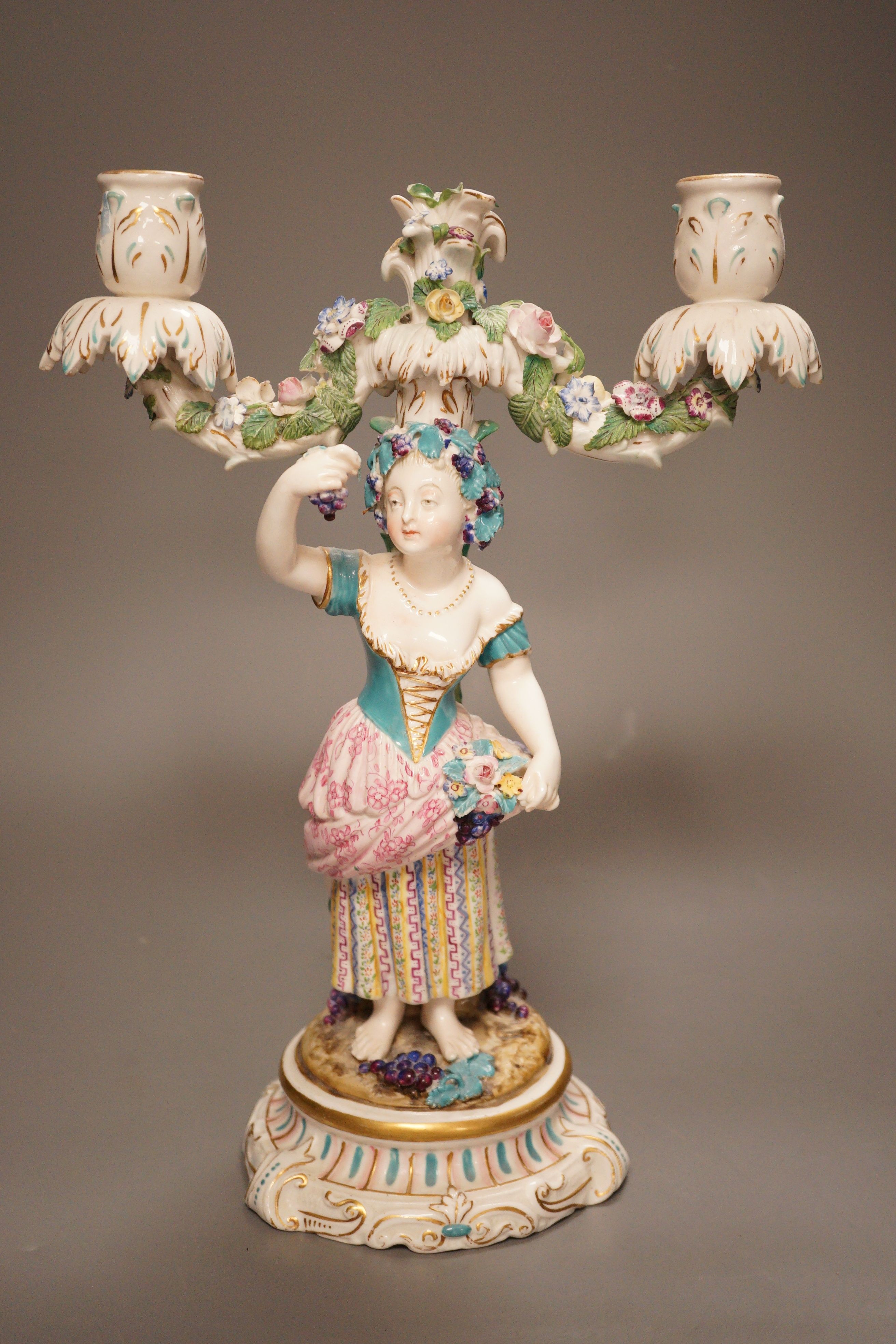 A 19th century English porcelain figural twin branch candelabrum, probably Minton, c.1835, 34cm                                                                                                                             