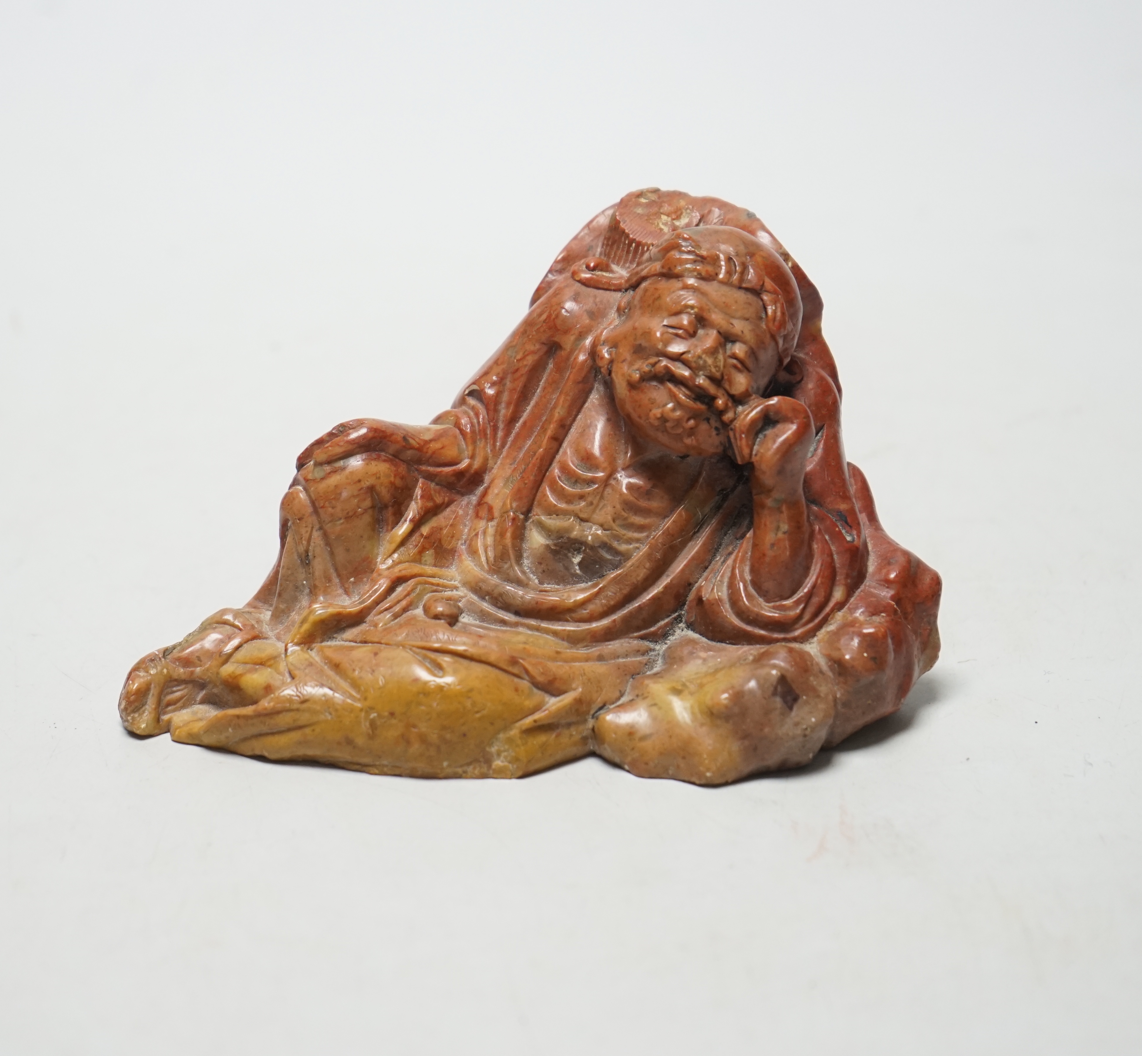 A 19th century Chinese soapstone figure of a Luohan, 12cm wide                                                                                                                                                              