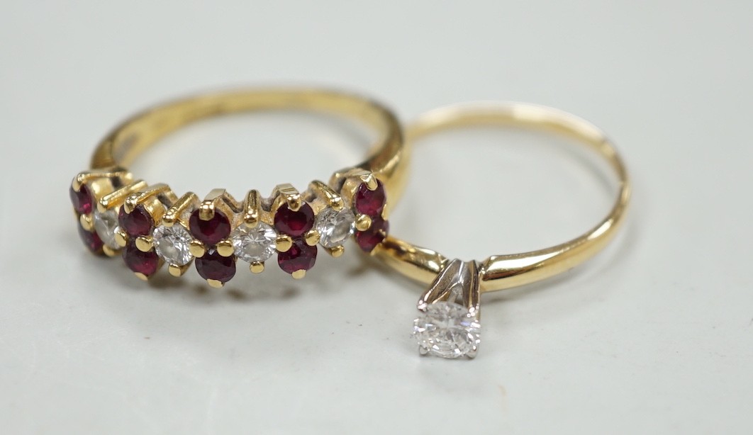 A modern 18ct gold, ruby and diamond cluster set half hoop ring, size L, gross weight 3.4 grams and a 14k and solitaire diamond set ring, size L, gross weight 1.1 grams.                                                   