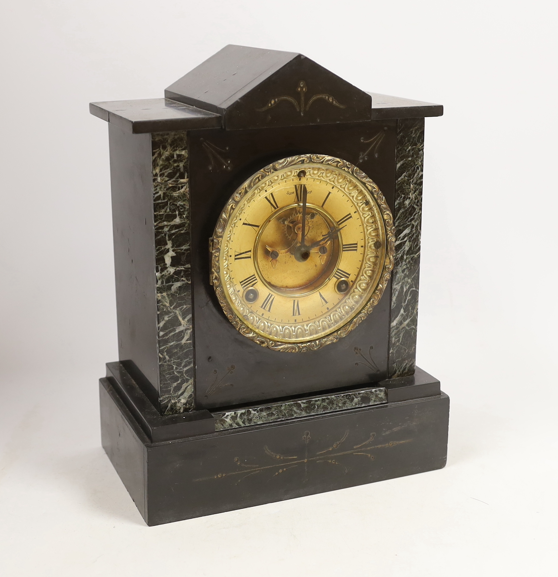 A Victorian slate mantel clock                                                                                                                                                                                              