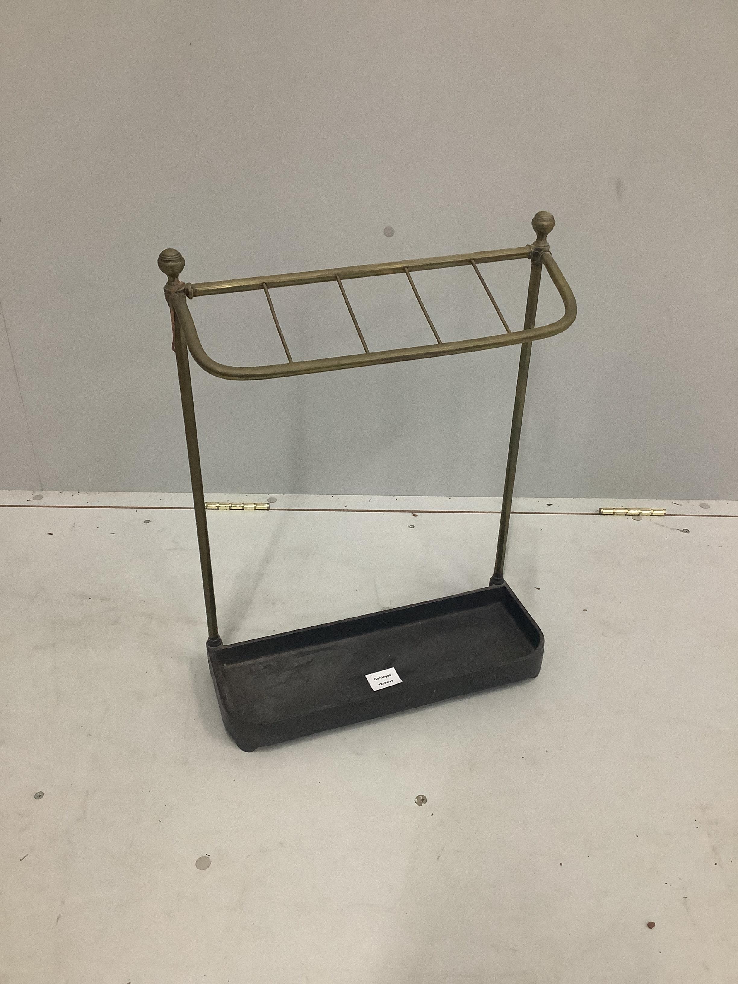 An Edwardian brass and cast iron five division stick stand, height 57cm together with four walking sticks                                                                                                                   