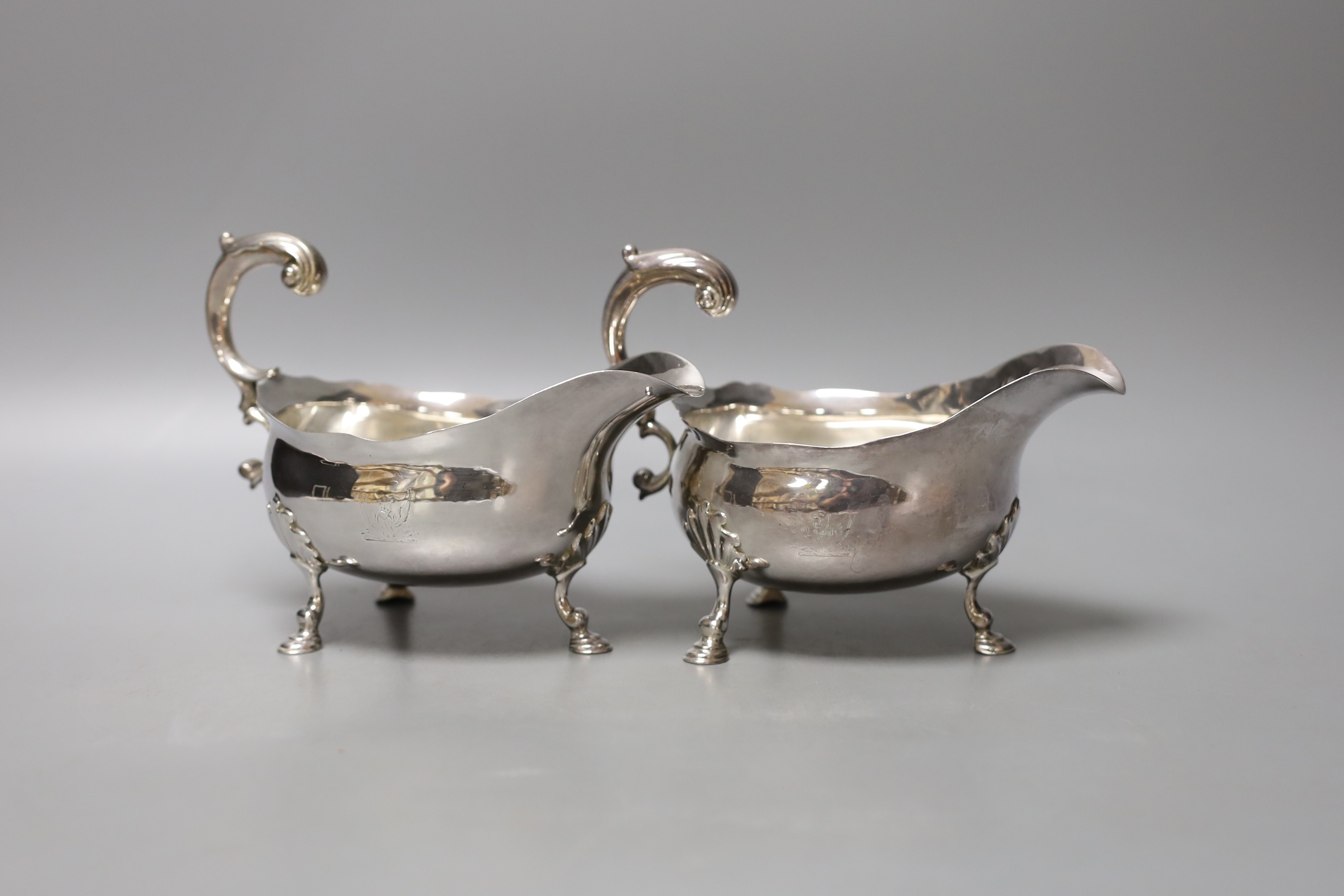 A pair of George II silver sauceboats, with flying scroll handles, maker's mark rubbed, London, 1752, height 12.8cm, 16.5oz.                                                                                                