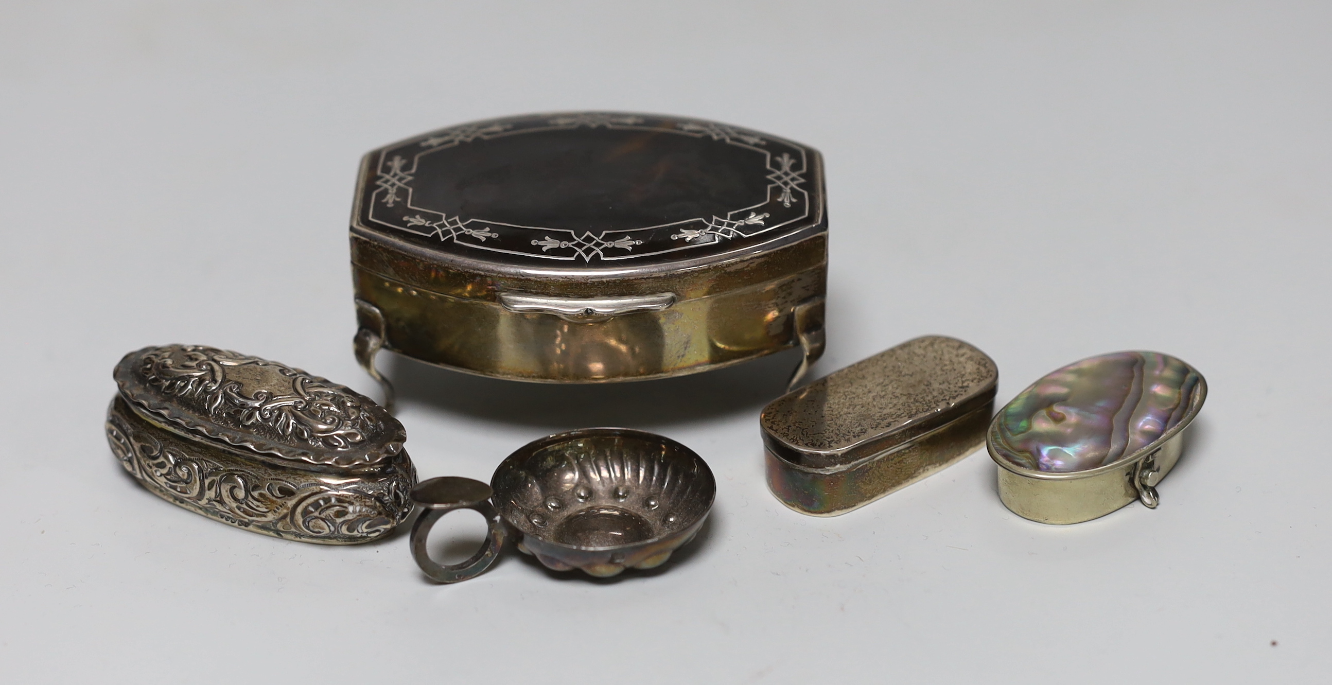 A George V silver and tortoiseshell mounted trinket box, Chester, 1915, 79cm, a late Victorian repousse box, a French taste vin and two later pill boxes.                                                                   