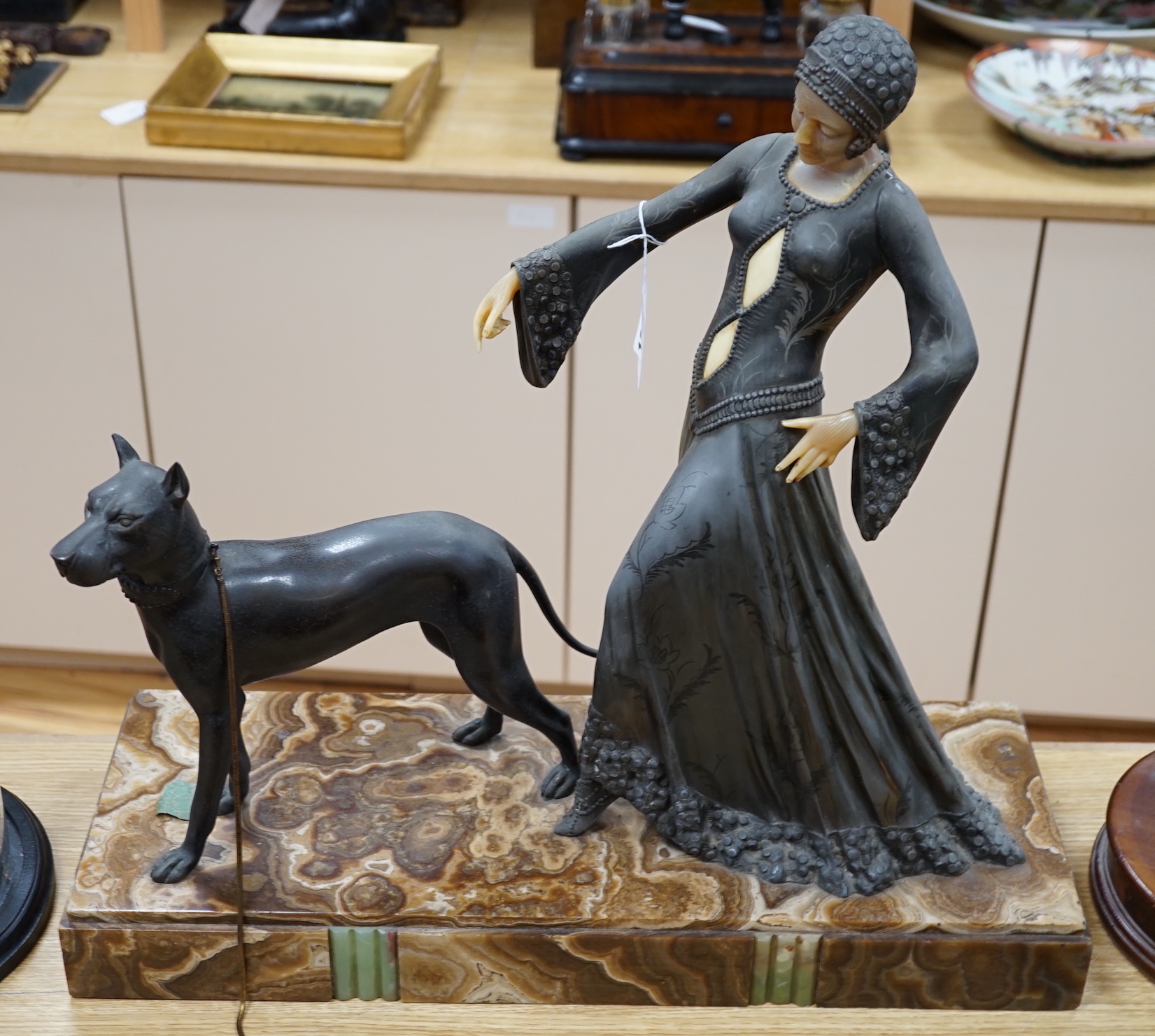 An Art Deco figure and dog, by G. Gori, on marble base, 55cm wide x 53cm high                                                                                                                                               