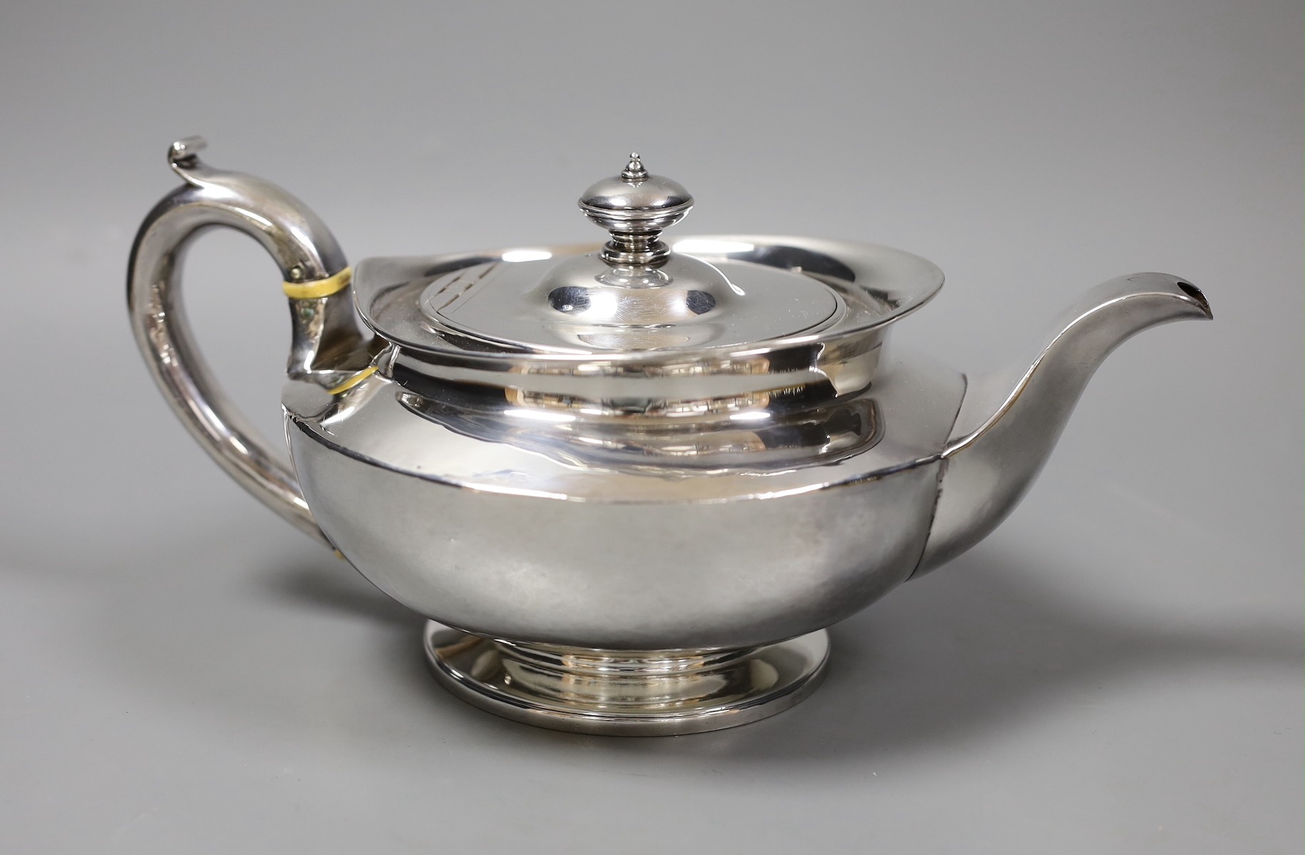 A George III squat circular silver teapot, by William Burwash, London 1820, gross 22oz.                                                                                                                                     