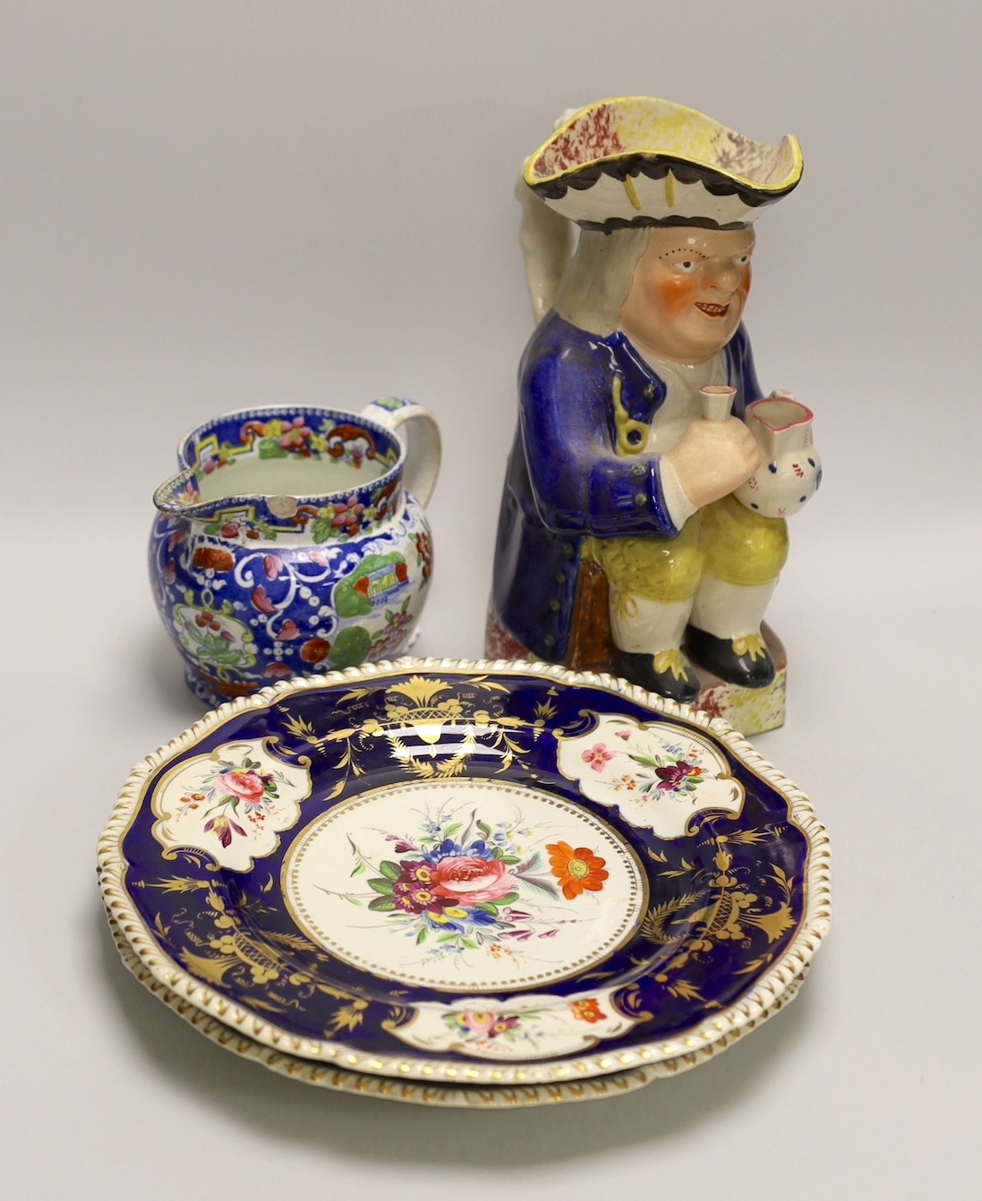 A pair of Derby plates, c.1820, an opaque china jug and a Toby jug. Tallest 24.5cm                                                                                                                                          