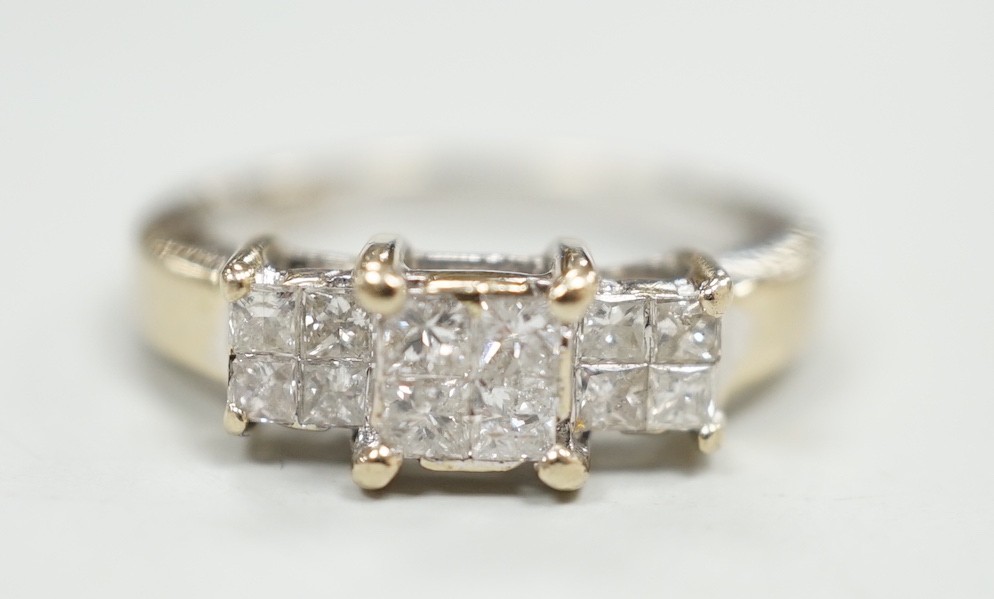 A modern 18ct white gold and triple princess cut diamond cluster set dress ring, size K, gross weight 5 grams.                                                                                                              