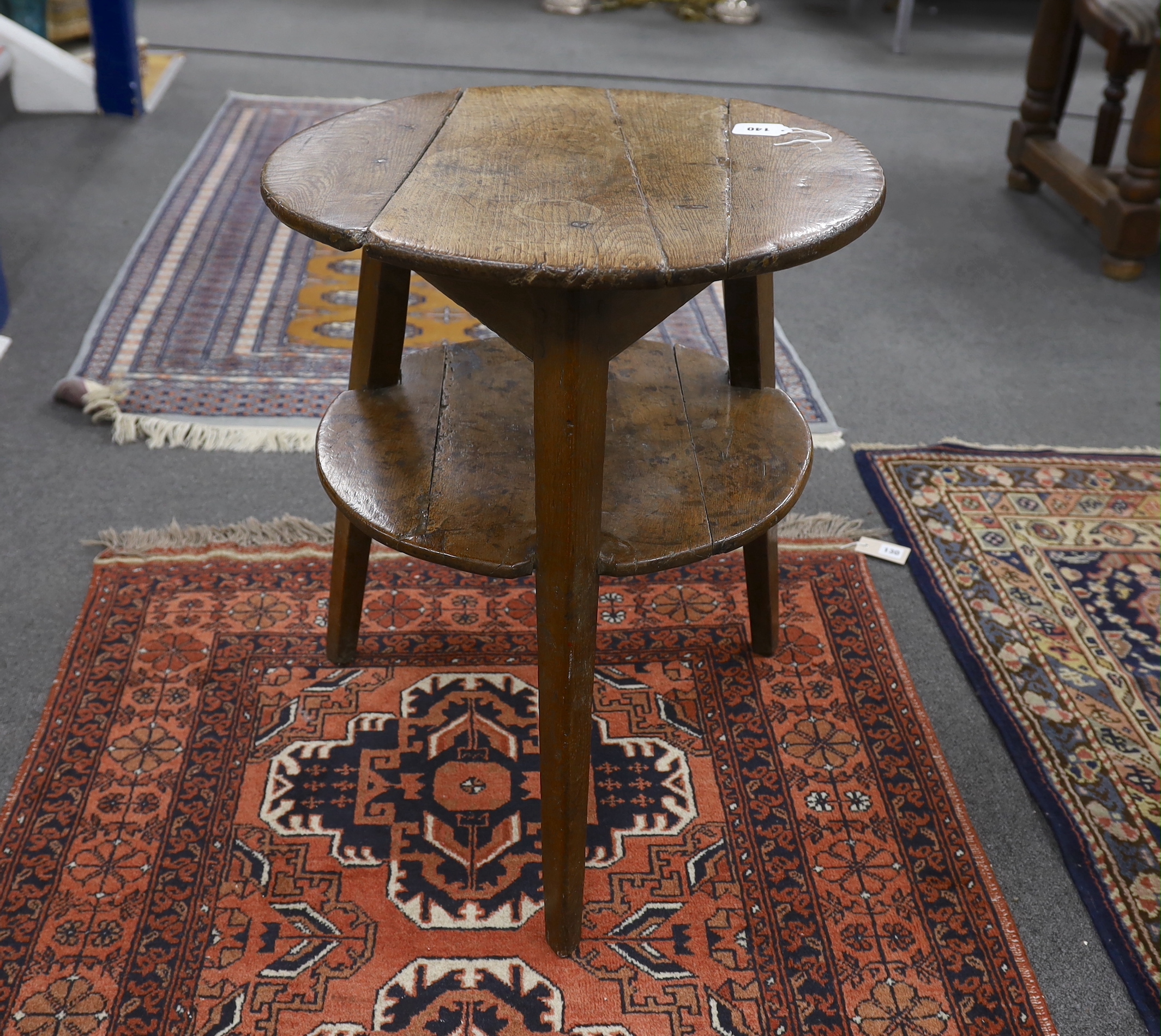 A late 18th / early 19th century circular oak two tier cricket table, diameter 55cm, height 66cm                                                                                                                            