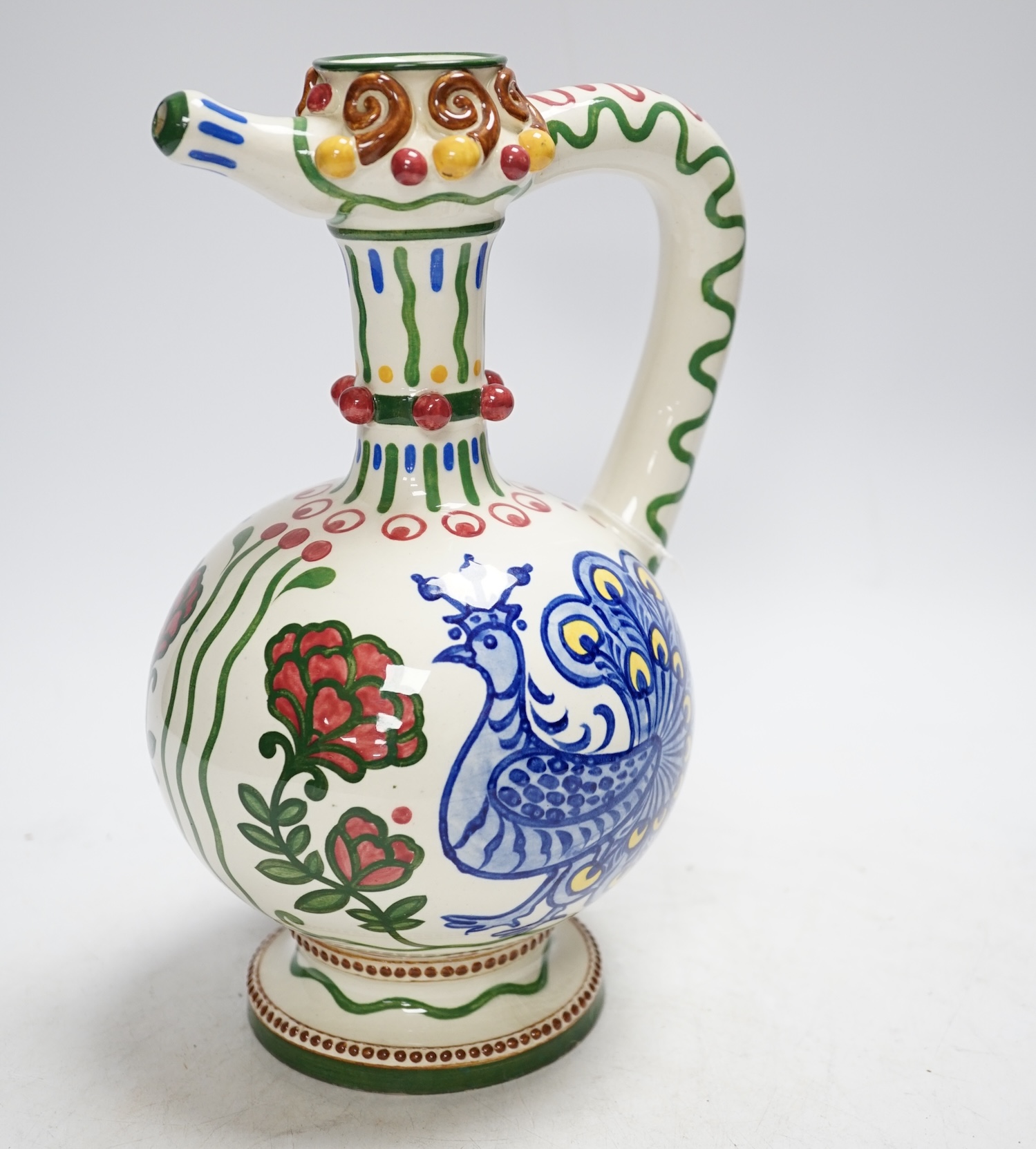 A Zsolnay jug or ewer decorated with peacocks and flowers, stamped ‘Zsolnay 830 and 07’ to the base, 24.5cm high                                                                                                            