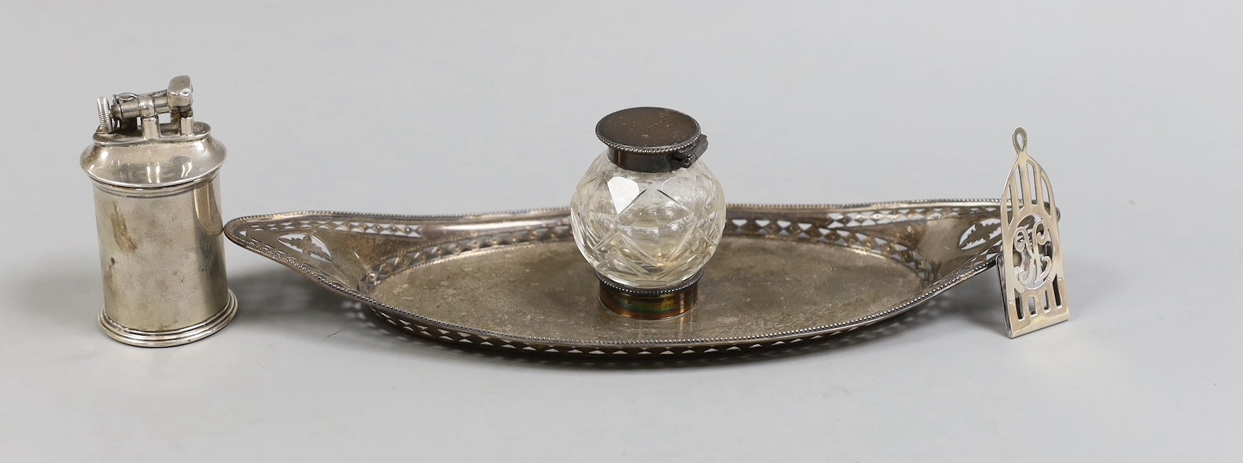 A late Victorian pierced silver mounted navette shaped inkstand, with silver mounted single glass well, Charles Stuart Harris, London, 1896, 26.5cm, together with a 1920's 'The Classic' silver mounted cylindrical lighter