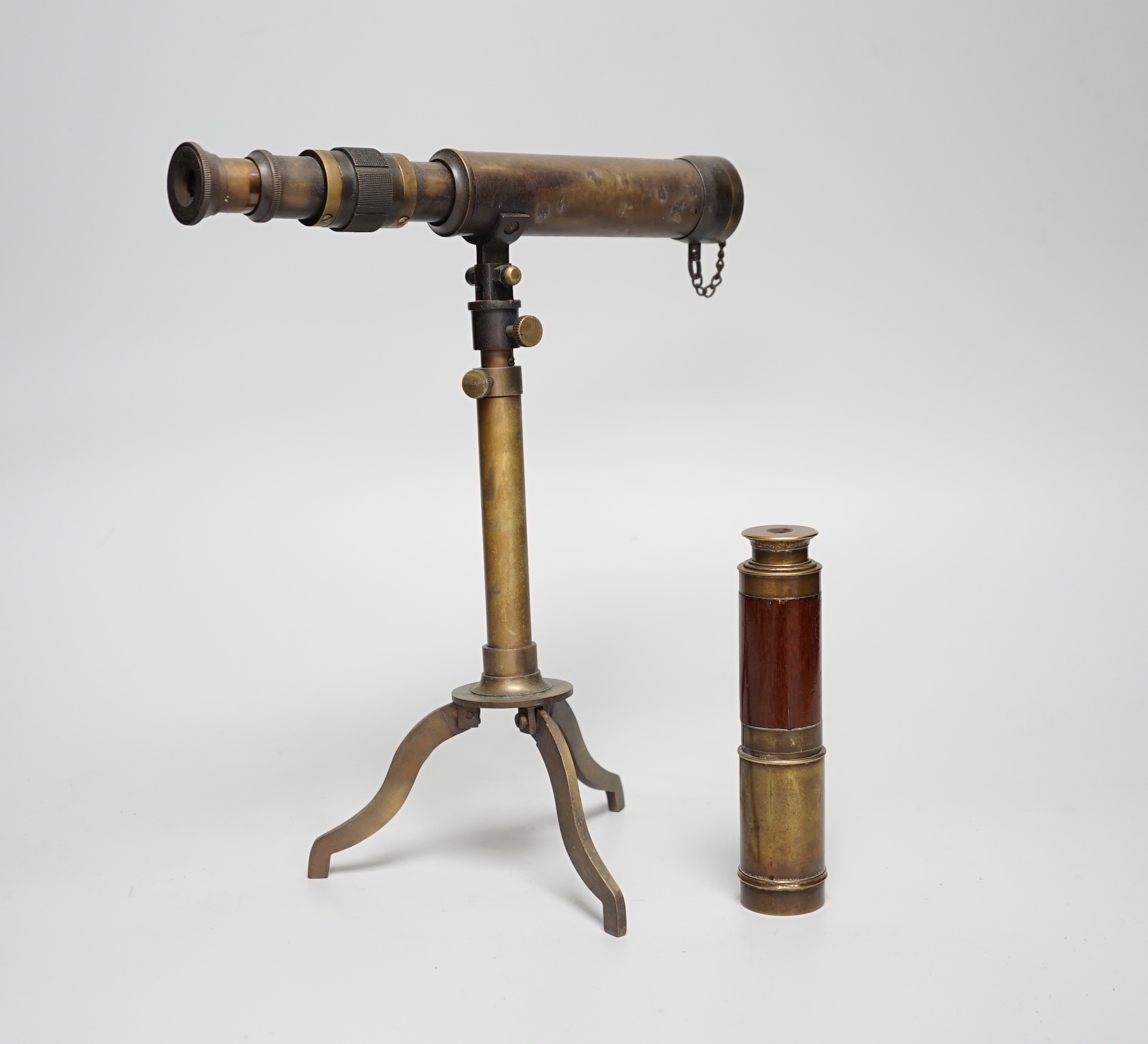 A brass telescope on tripod stand, signed Ottway, Ealing, 28cm high, together with a three-draw telescope                                                                                                                   