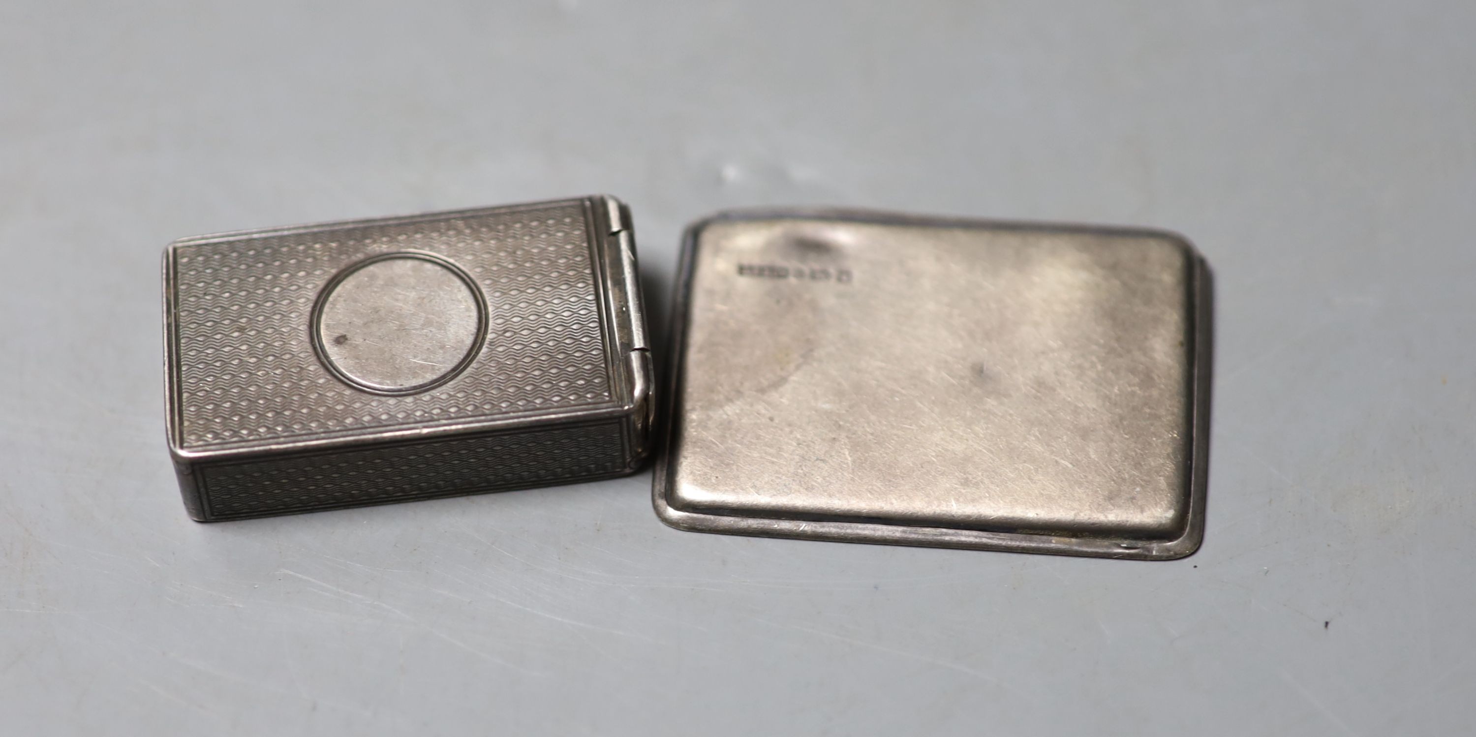 A Victorian engine turned silver vesta case, George Adams, London, 1879, 45mm and a later silver stamp case, 52mm.                                                                                                          