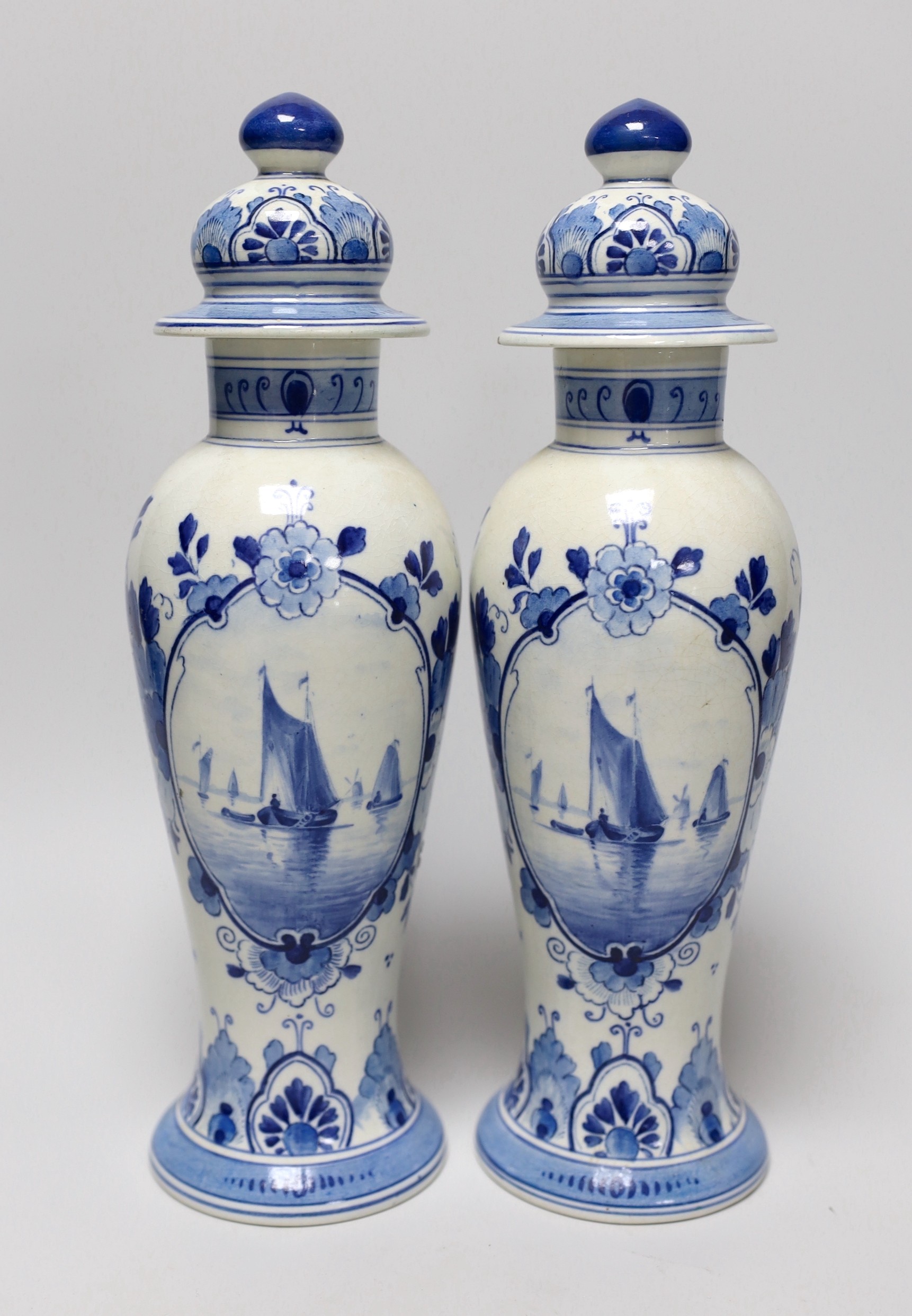 A pair of blue and white Delft vases and covers, 28cm                                                                                                                                                                       
