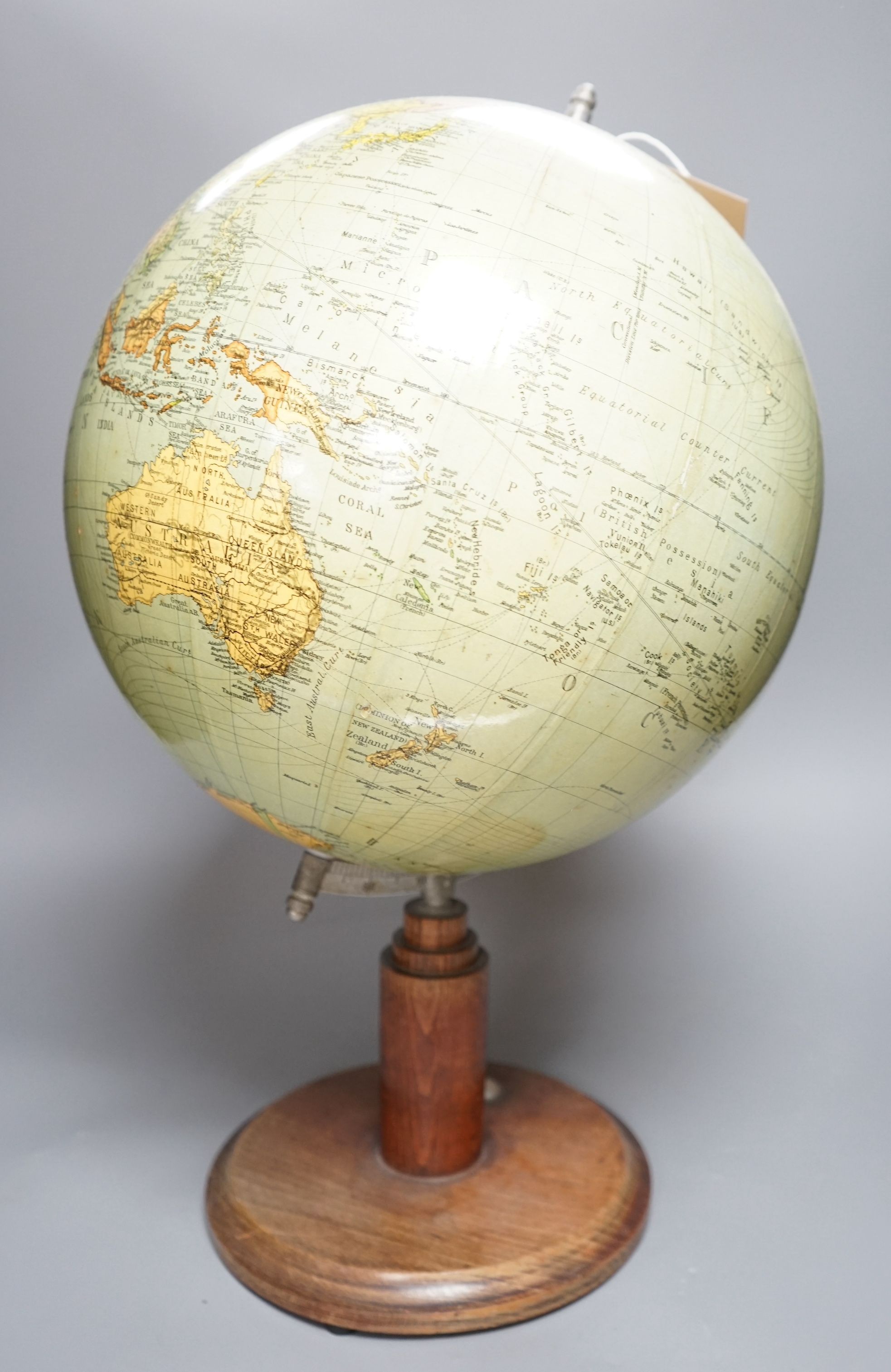 A mid 20th century globe on a revolving stand with an inset compass, 54cms high including stand                                                                                                                             