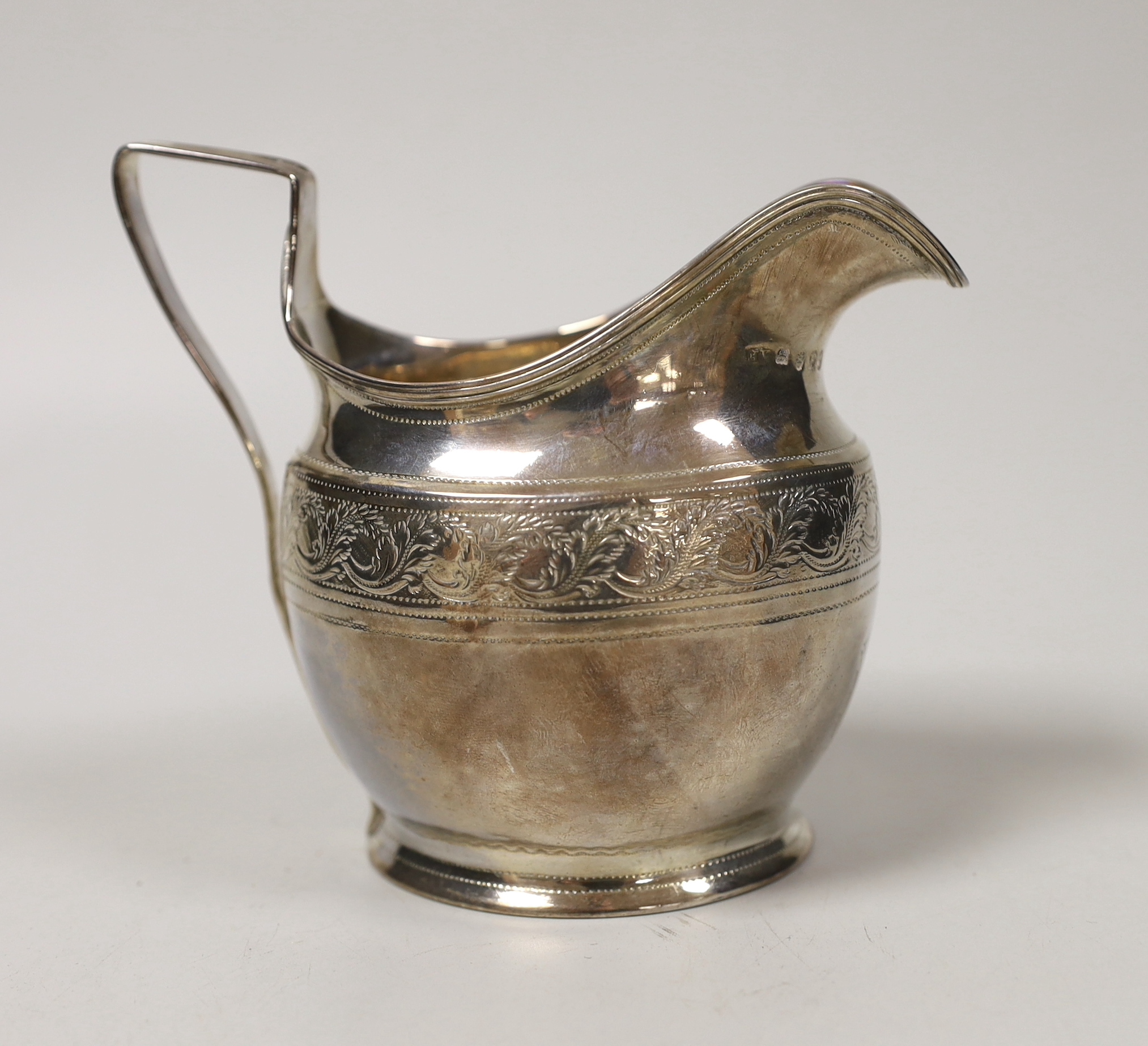 A George III engraved silver helmet shaped cream jug, Andrew Fogelburg, London, 1801, height 10.2cm, 4.7oz.                                                                                                                 