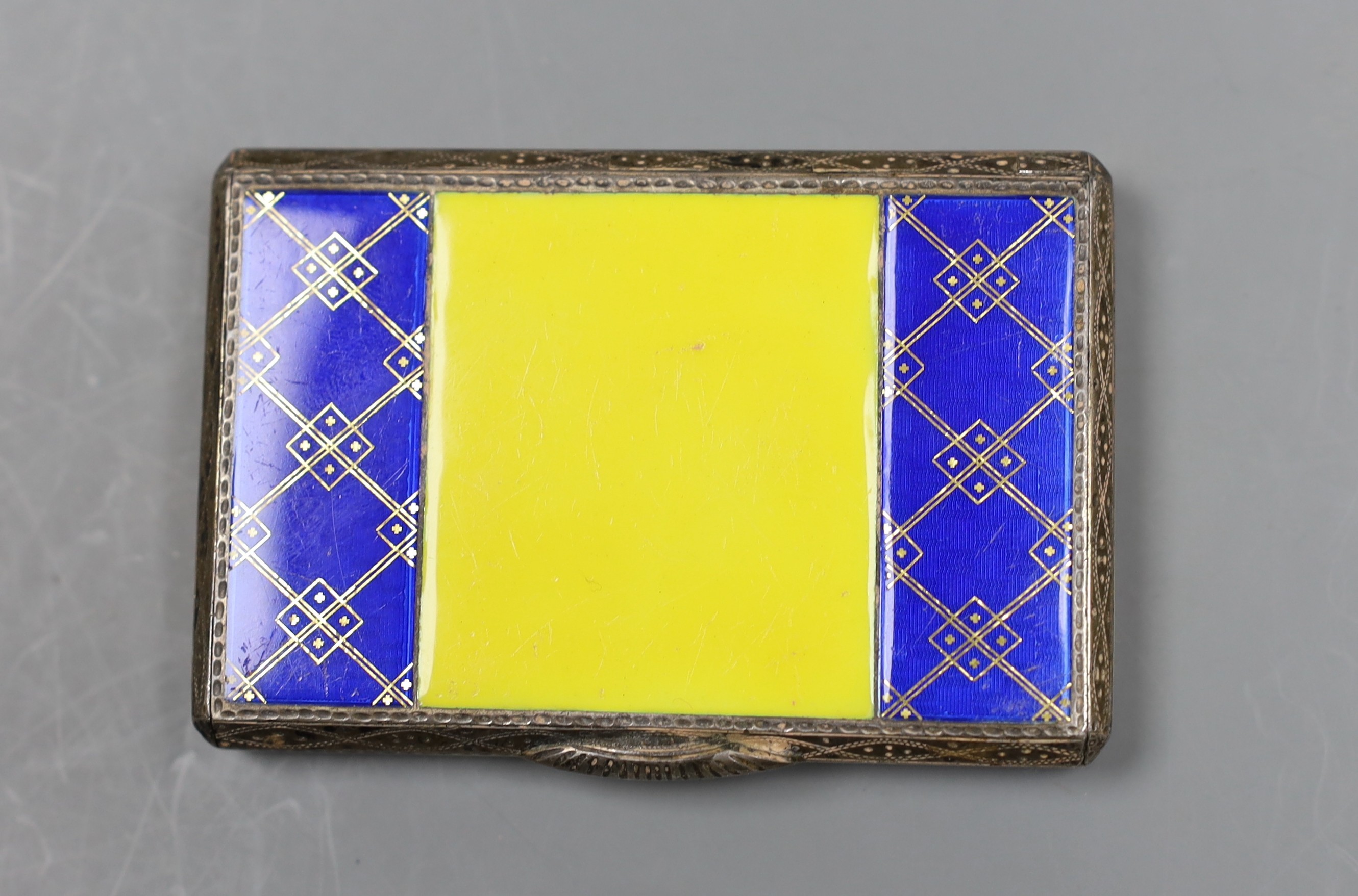 A George V silver and two colour enamel rectangular cigarette case, import marks for Glasgow, 1926, 79mm.                                                                                                                   
