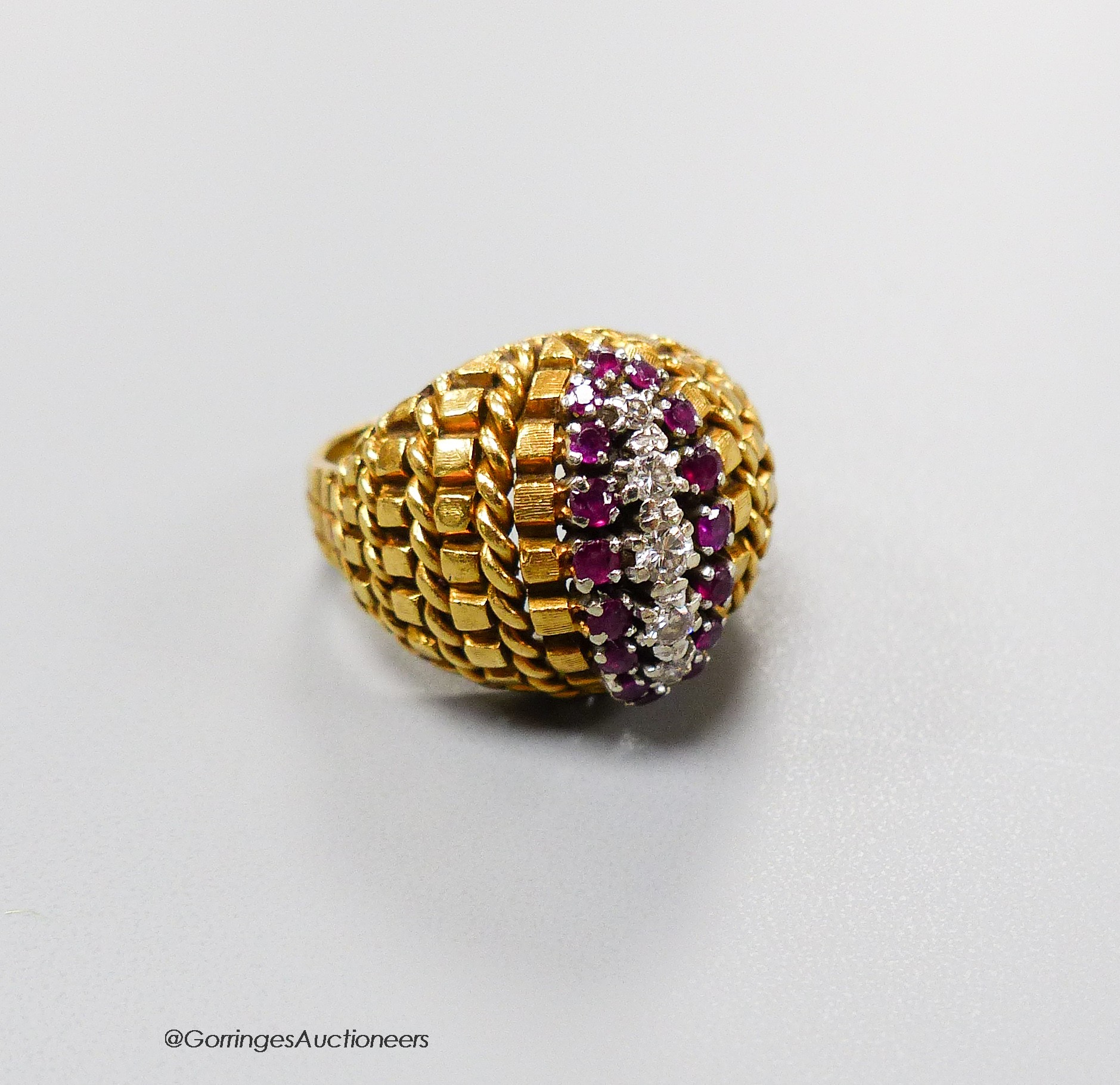 An early 1970's 14ct gold, ruby and diamond set dress ring, size L, gross 9.1 grams.                                                                                                                                        