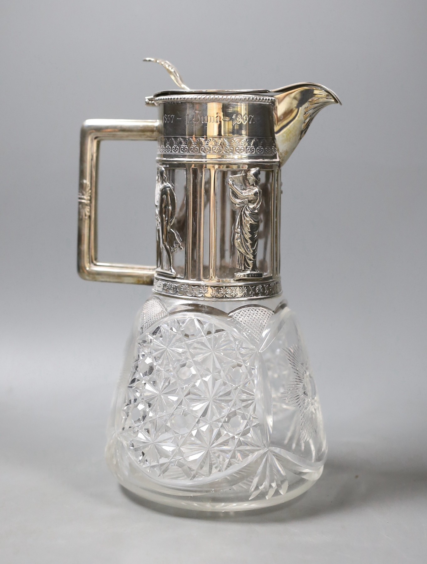 A late 19th/early 20th century German 800 standard white metal mounted cult glass claret jug, retailed by Friedlaender, height 26.2cm.                                                                                      