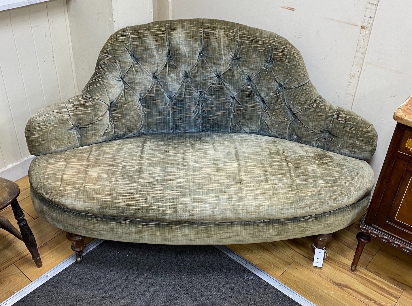A Victorian upholstered settee with deep buttoned back, length 140cm, depth 56cm, height 77cm                                                                                                                               