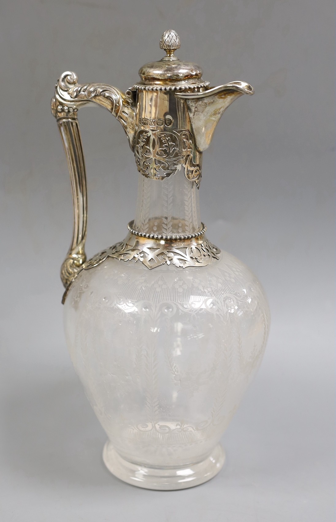 A Victorian silver mounted etched glass claret jug, by W & G Sissons, Sheffield, 1865, the glass with monogram and dated 1867, height 27.4cm.                                                                               