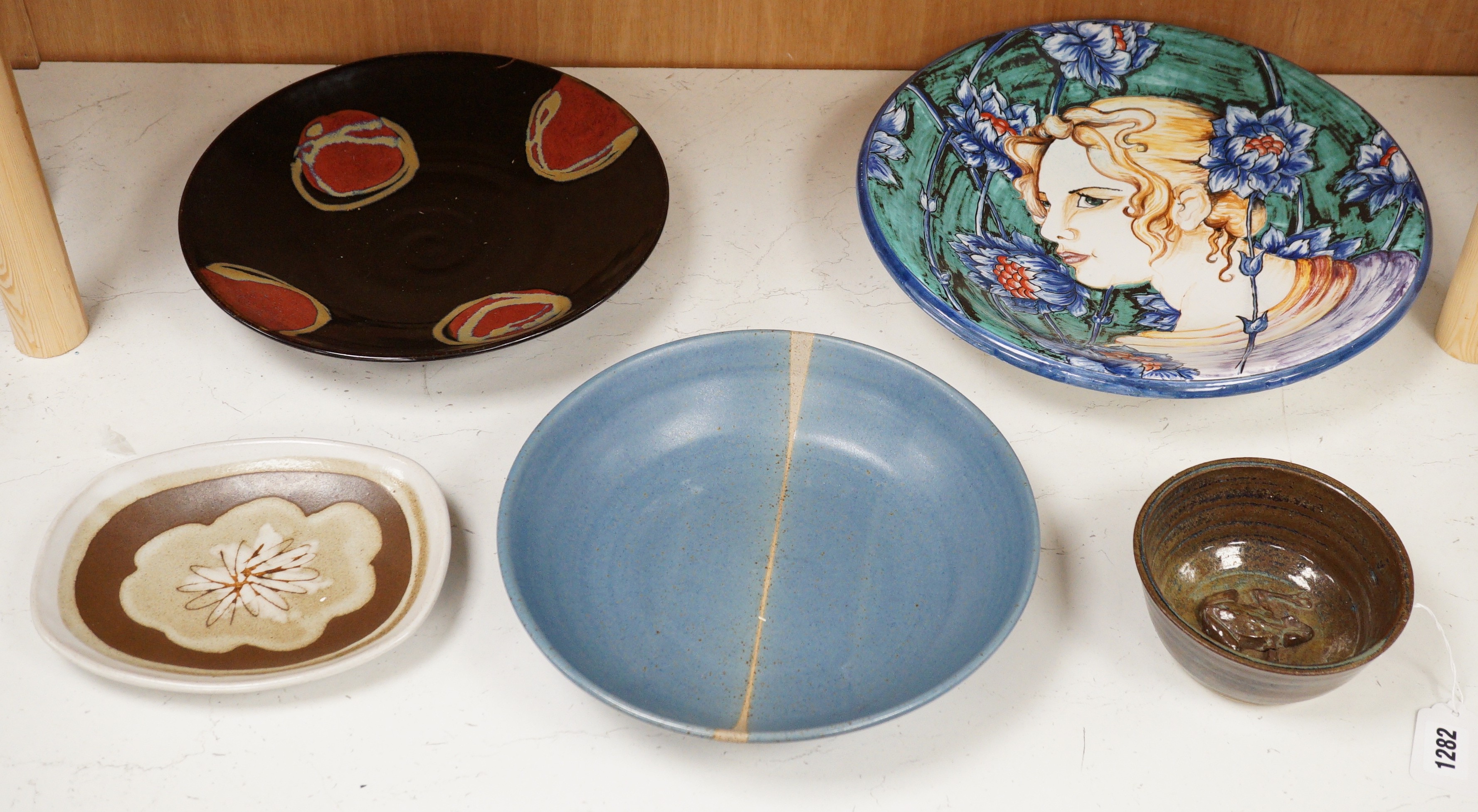 Five Studio pottery dishes, to include a John Harlow frog bowl, Marianne de Trey dish, David Melville dish, Tony Gants bowl, and another decorative painted dish, largest 35cm diameter                                     