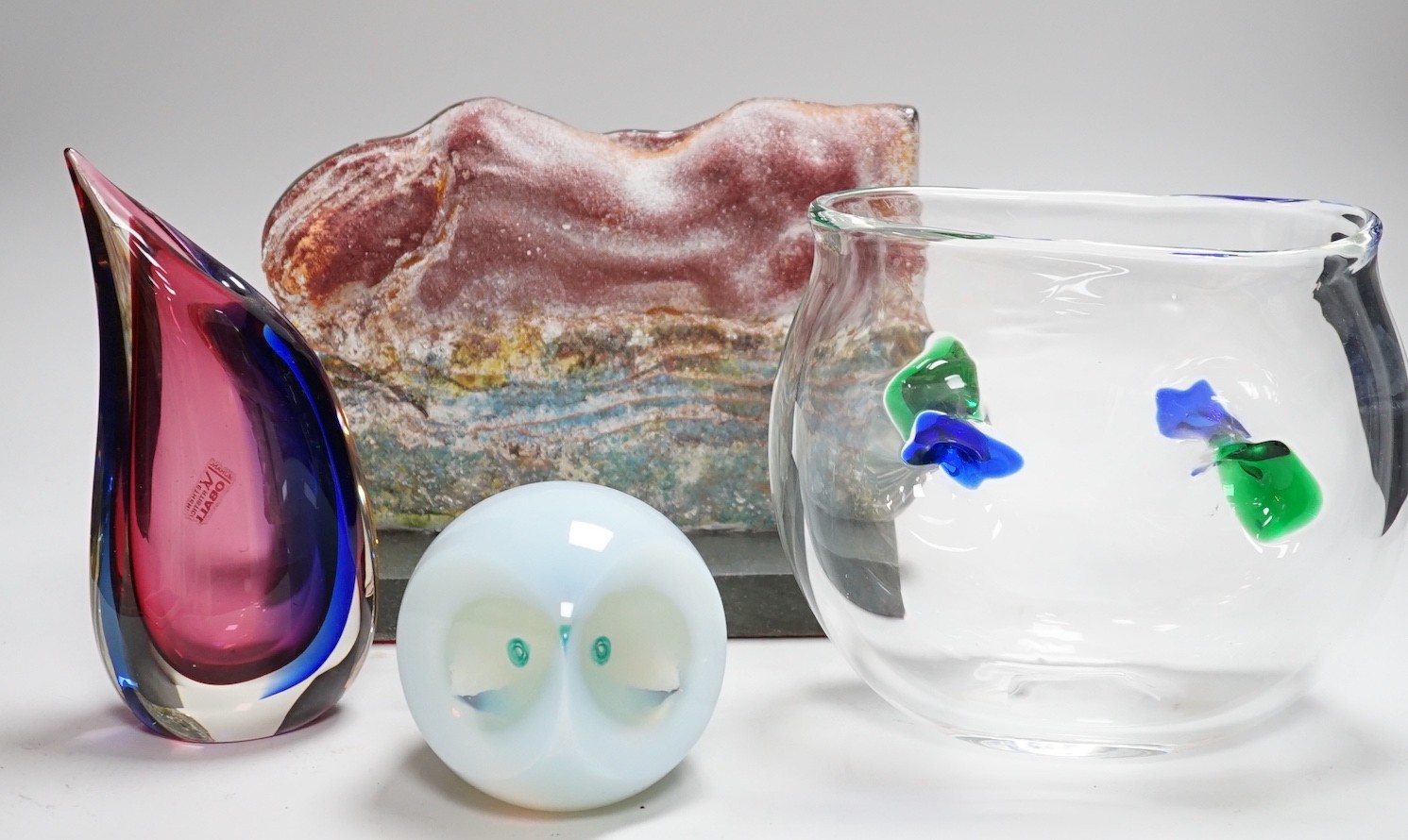 A Murano Oball Vase from Vetreria Artistica, 20cm, a free form green, blue and clear glass vase, 18cm high, an opalescent glass owl paperweight and a slumped glass slab sculpture on stand 25cms wide x 19cms              