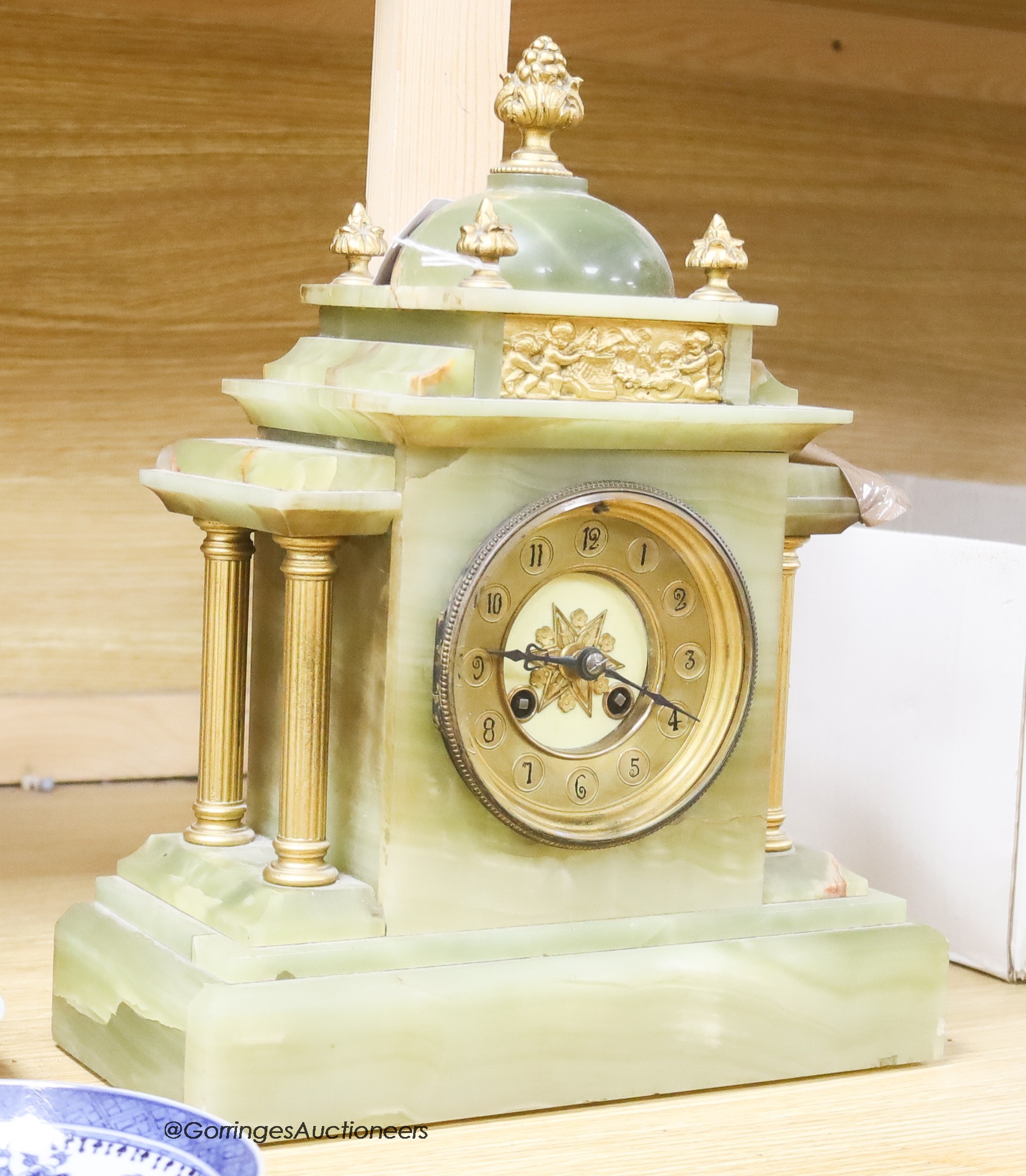 A French onyx and gilt metal mantel clock, with pendulum and key, height 34cm                                                                                                                                               