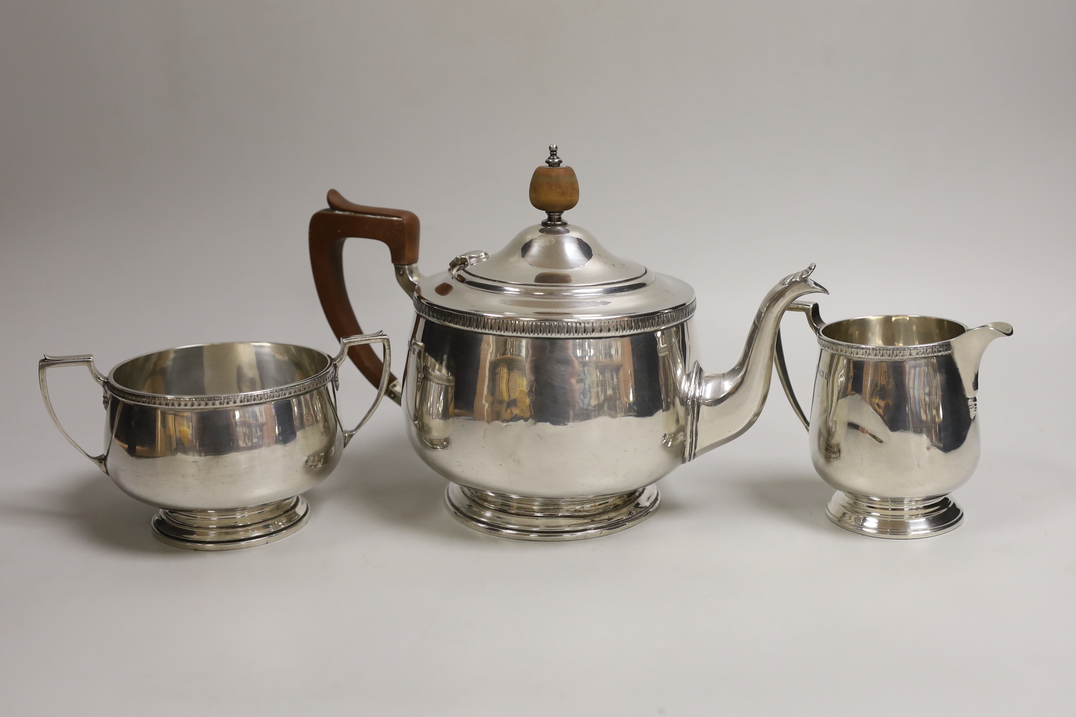 A George V silver circular three piece tea set, Alexander Clark Co, Birmingham, 1930, gross weight 26.3oz.                                                                                                                  