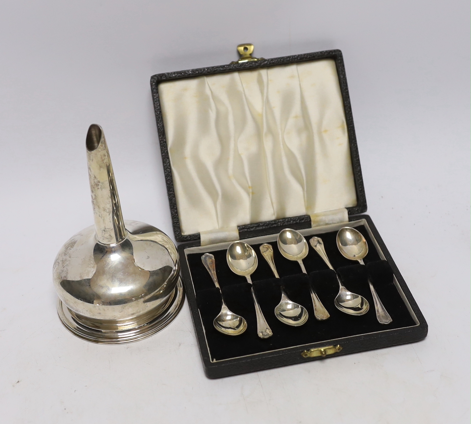 A modern silver wine funnel, Broadway & Co, London, 2003, 13.1cm and a cased set of six earlier silver coffee spoons.                                                                                                       