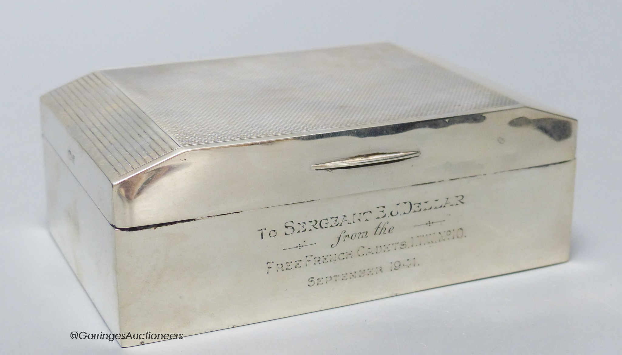 A George VI silver cigarette box, with military related inscription, Birmingham, 1939, 13.7cm, gross weight 14oz.                                                                                                           