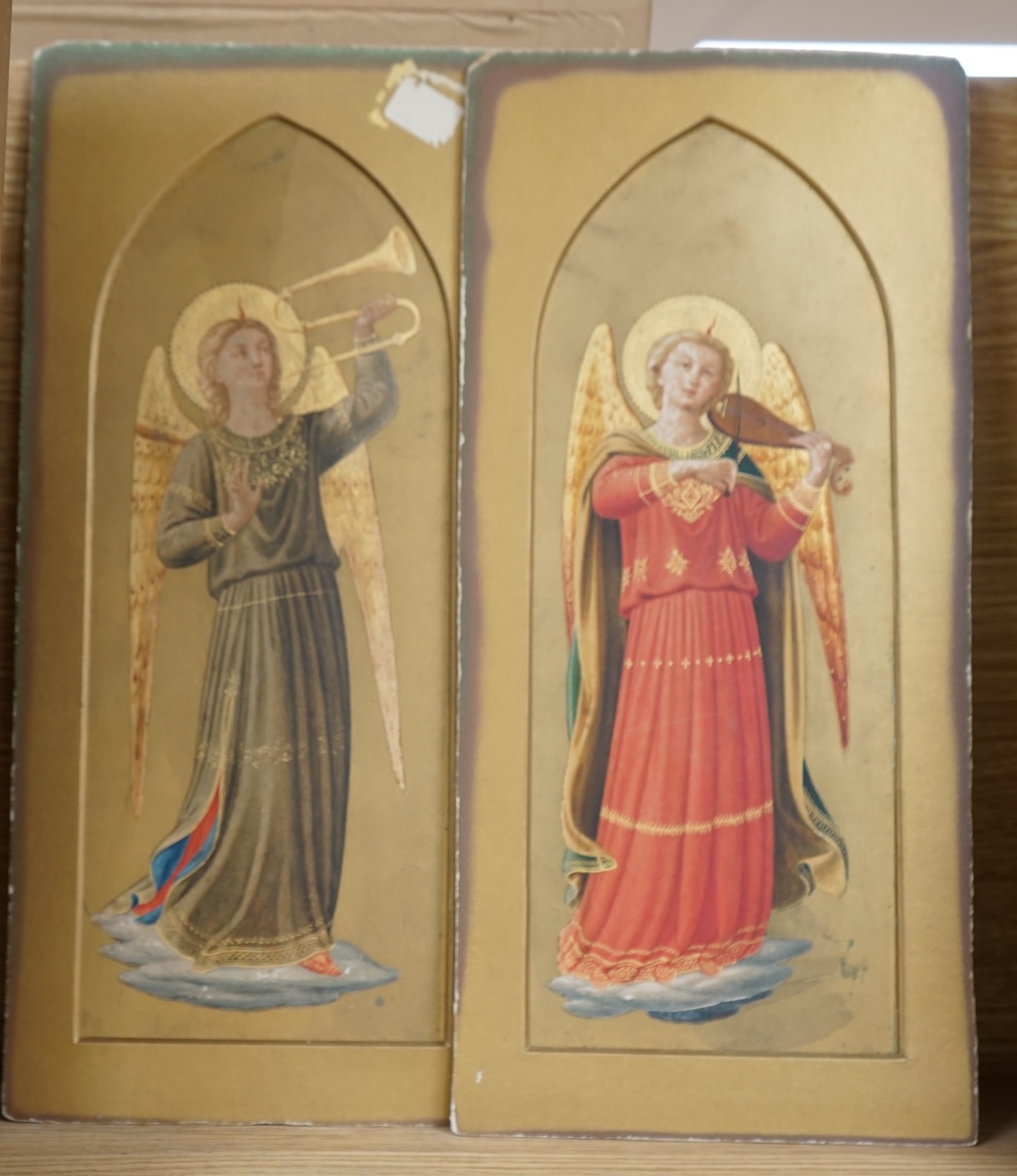 Style of Fra Angelico (Italian), pair of 19th century gilt and watercolour studies, Heralding angels, 31 x 11cm, mounted, unframed. Condition - fair, general wear                                                          